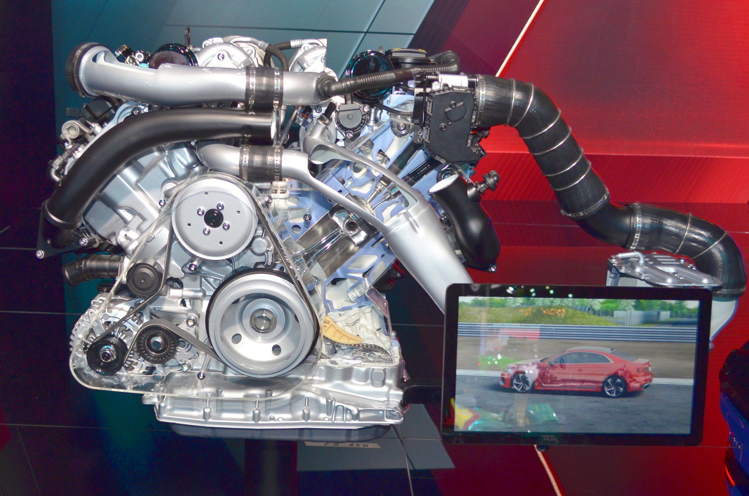 Turbocharged high-performance engine with intake pipes and belt system.