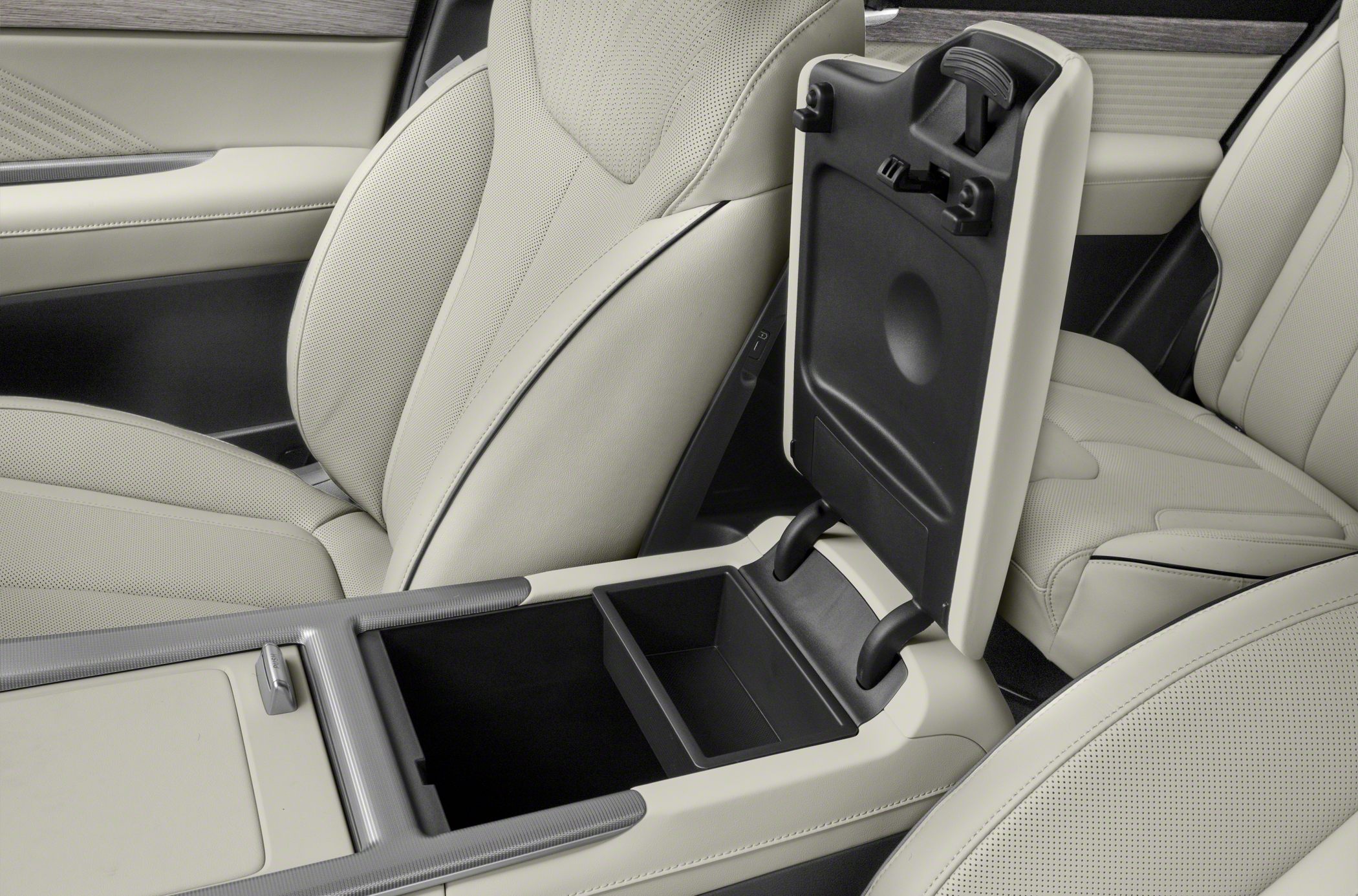 Open center console storage with beige leather seats