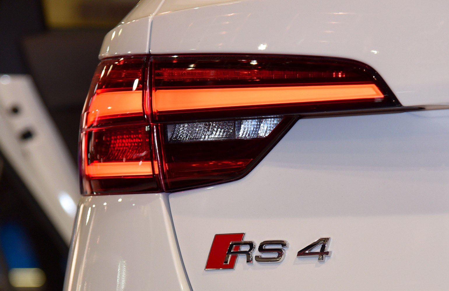 Rear LED tail light and RS 4 badge on white car