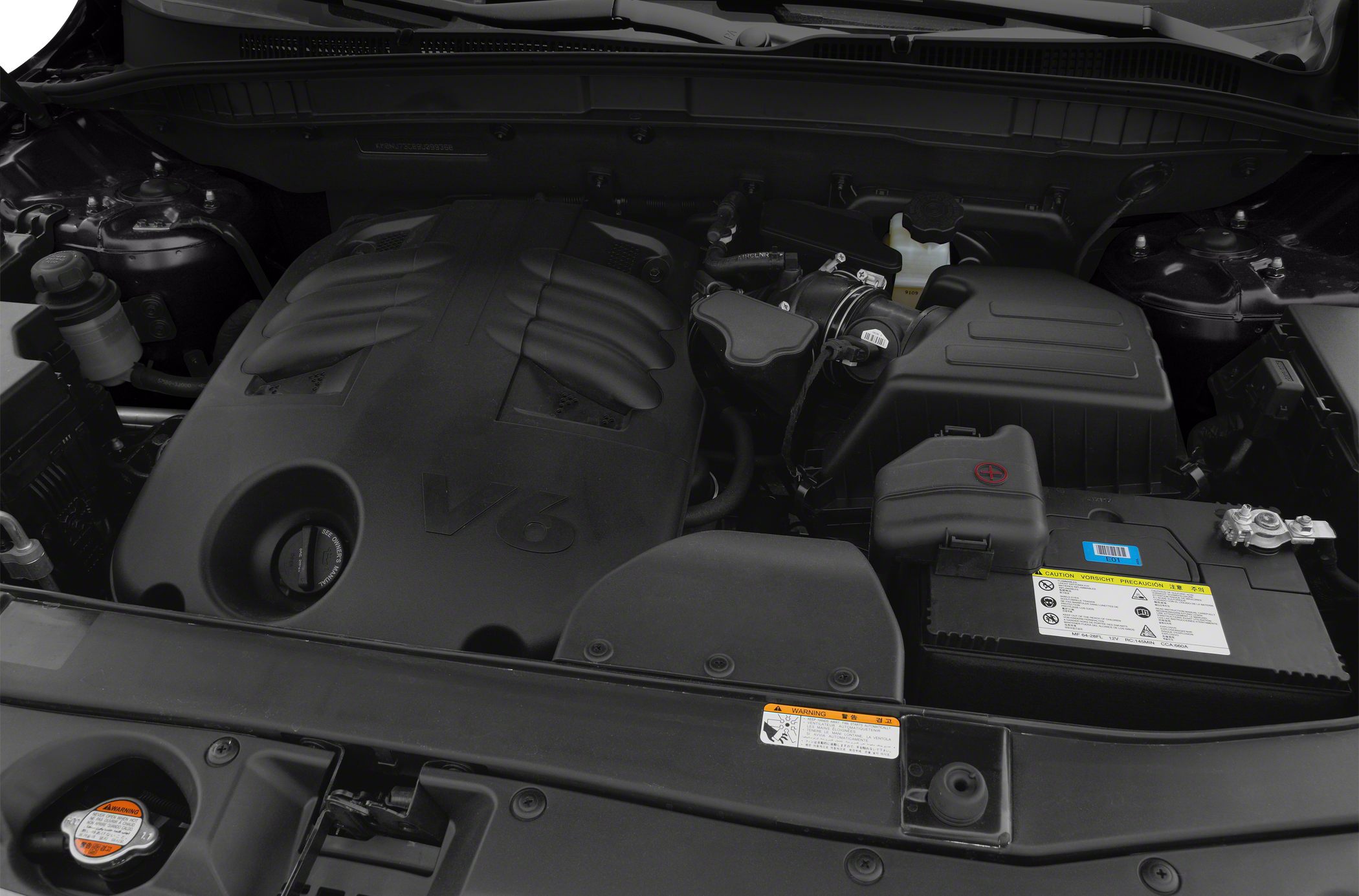 Close-up of V6 engine compartment with engine cover and adjacent components.