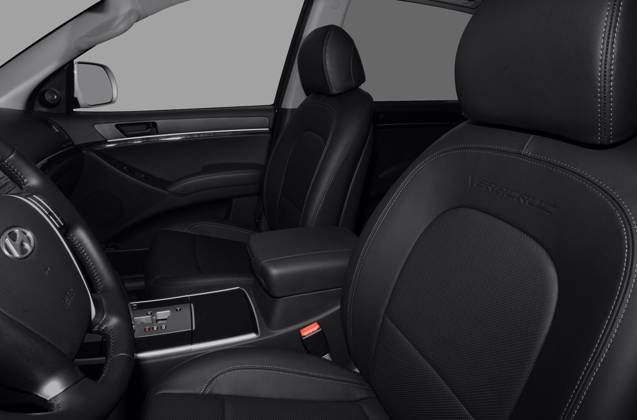 Black leather seats and interior with steering wheel and center console.