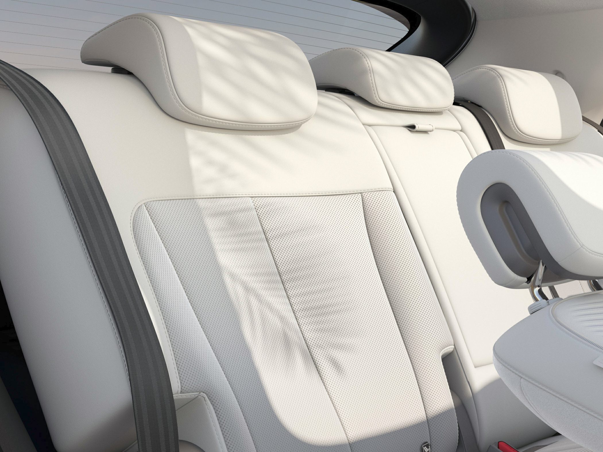 White leather rear seats with headrests and detailed upholstery stitching