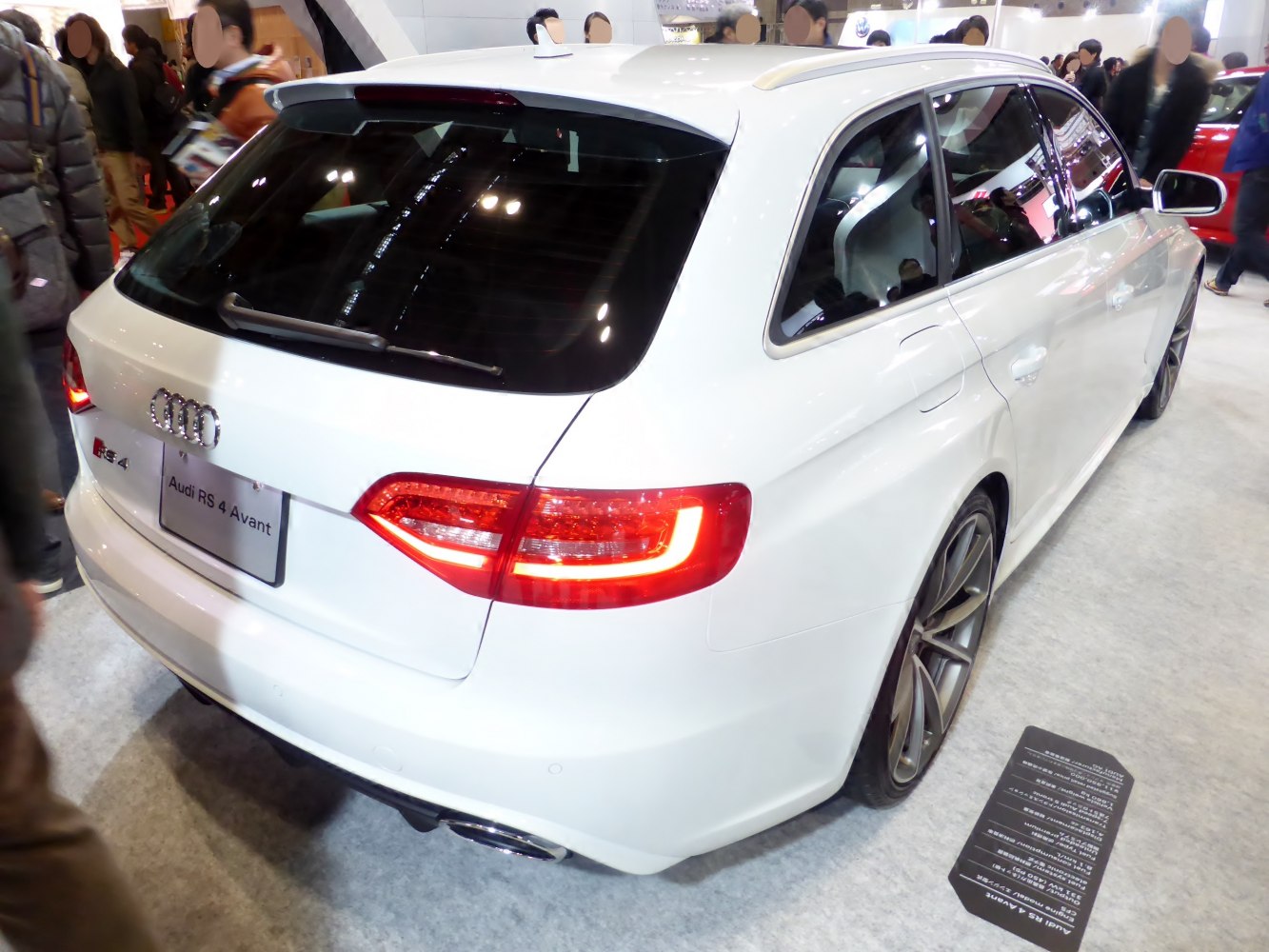 Rear and side view of white station wagon featuring LED taillights and rear spoiler