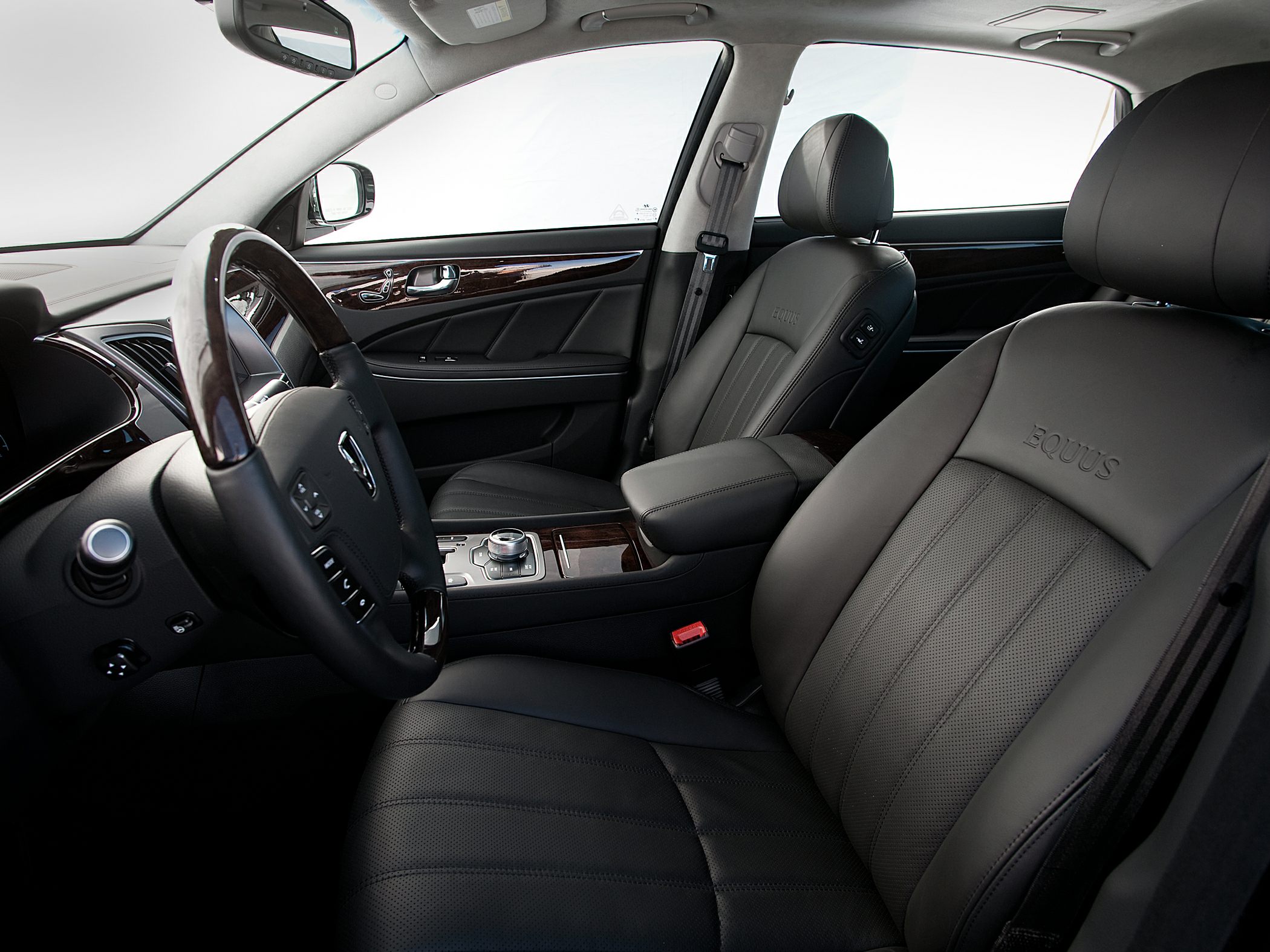 Black leather seats with wood trim and modern steering wheel controls.