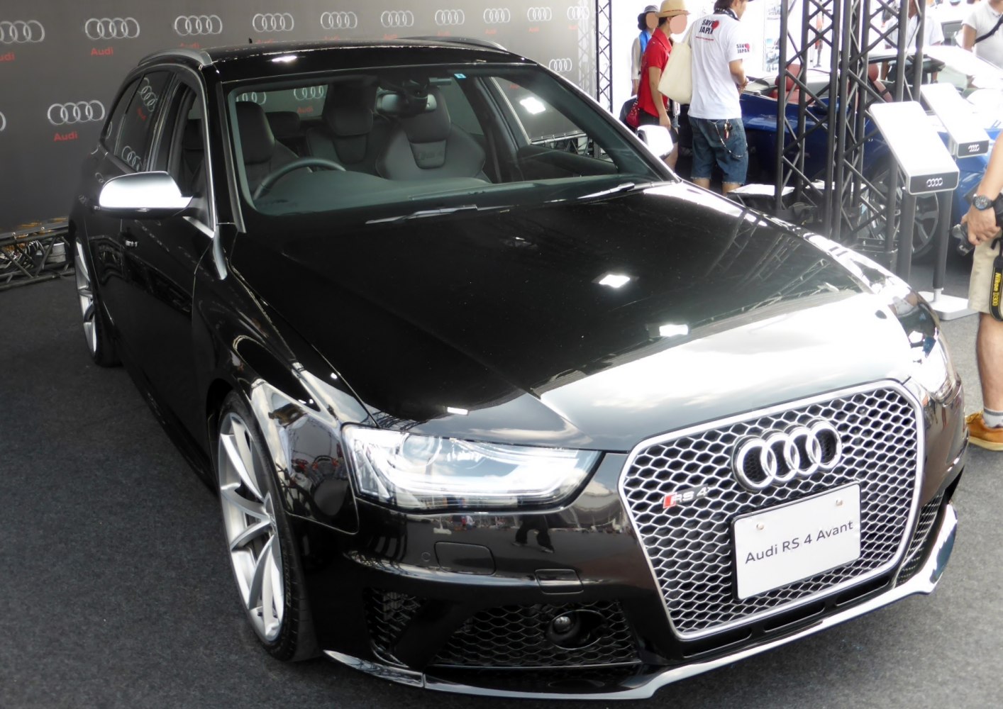 Front grille and headlights of a glossy black performance wagon