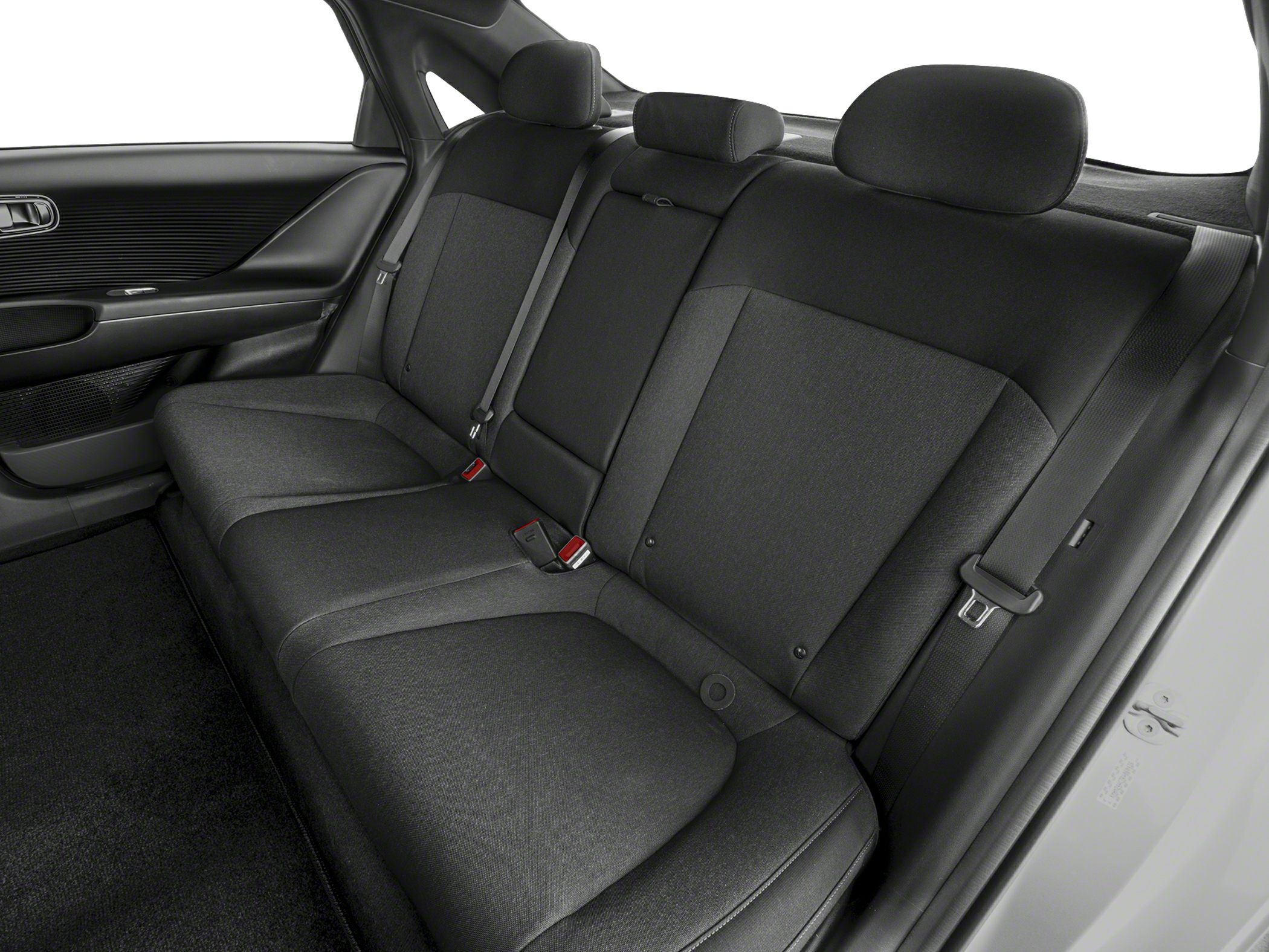 Rear seat interior with fabric upholstery, seat belts, and headrests.