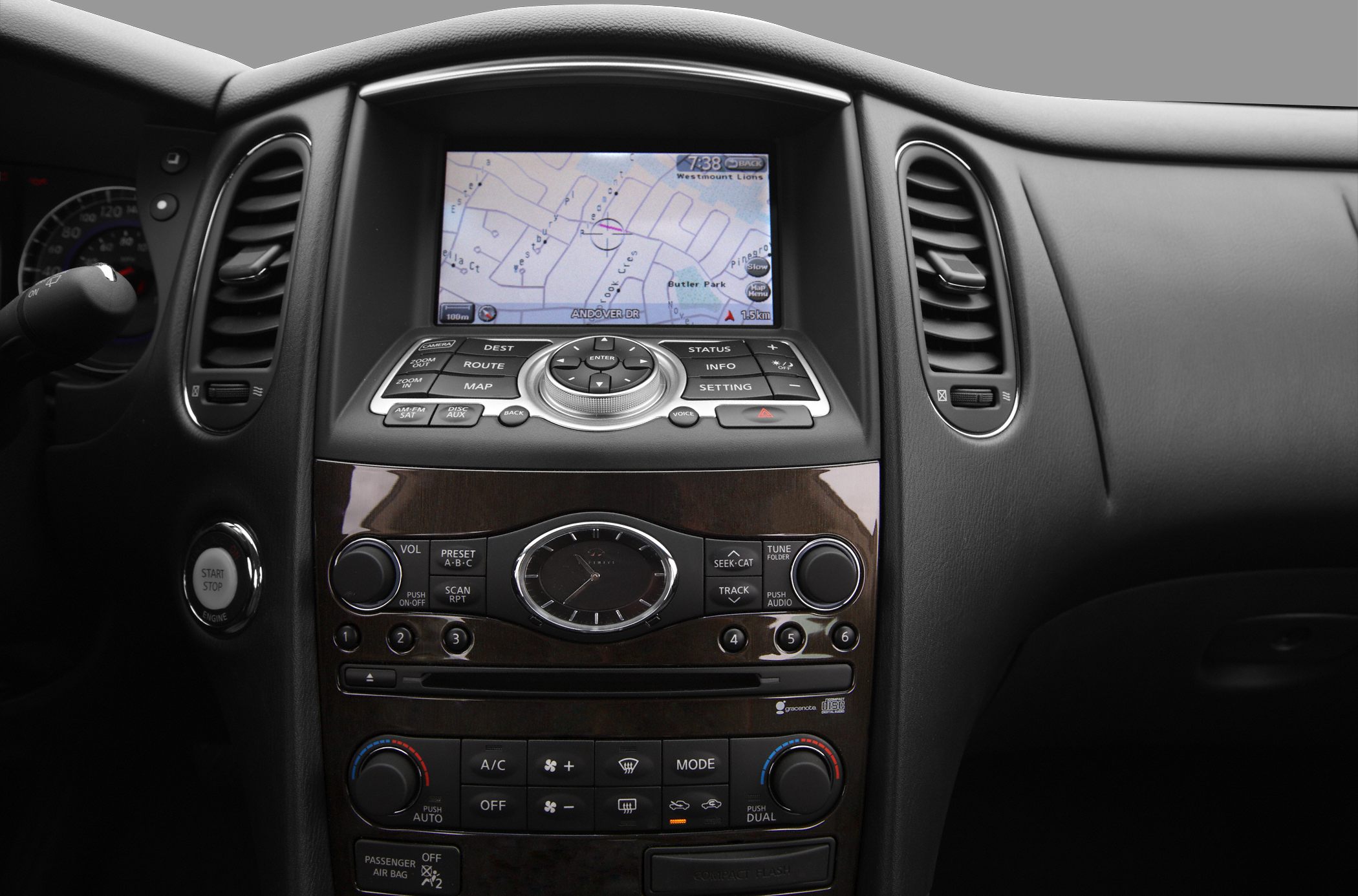 Dashboard navigation system, climate controls, analog clock, and multimedia interface.