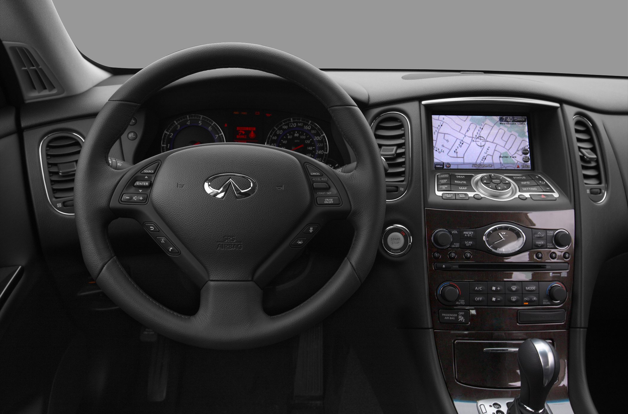 Steering wheel with control buttons and dashboard with navigation screen