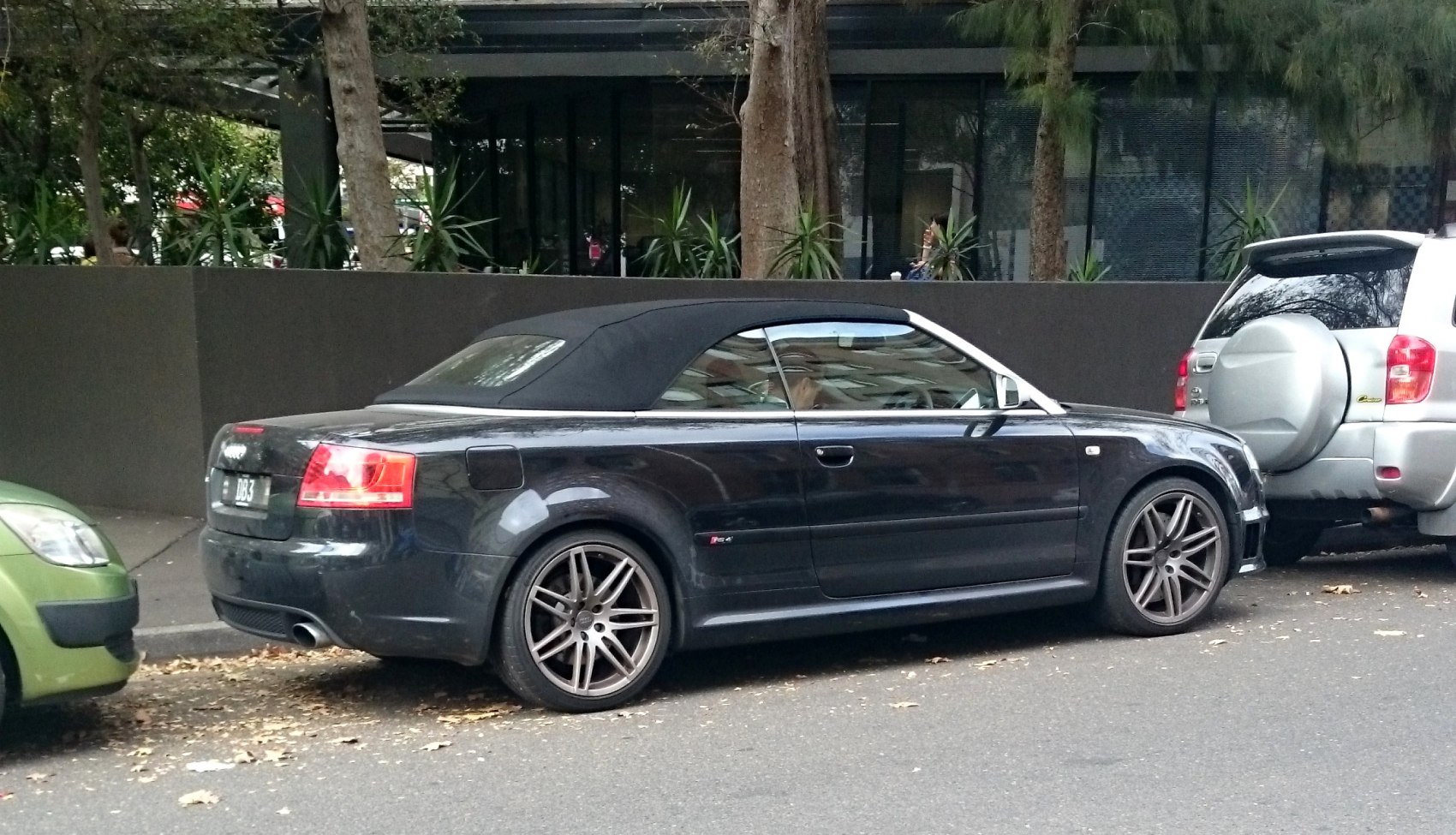 Black convertible with sporty alloy wheels and soft top roof