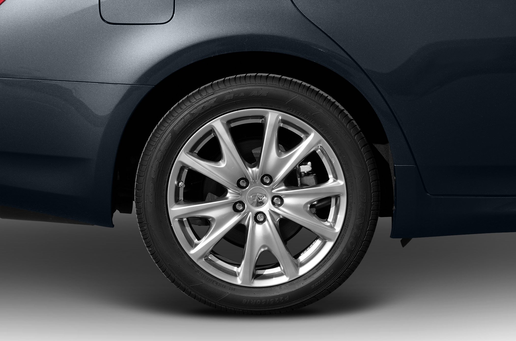 Close-up of alloy wheel and rear side panel of a car