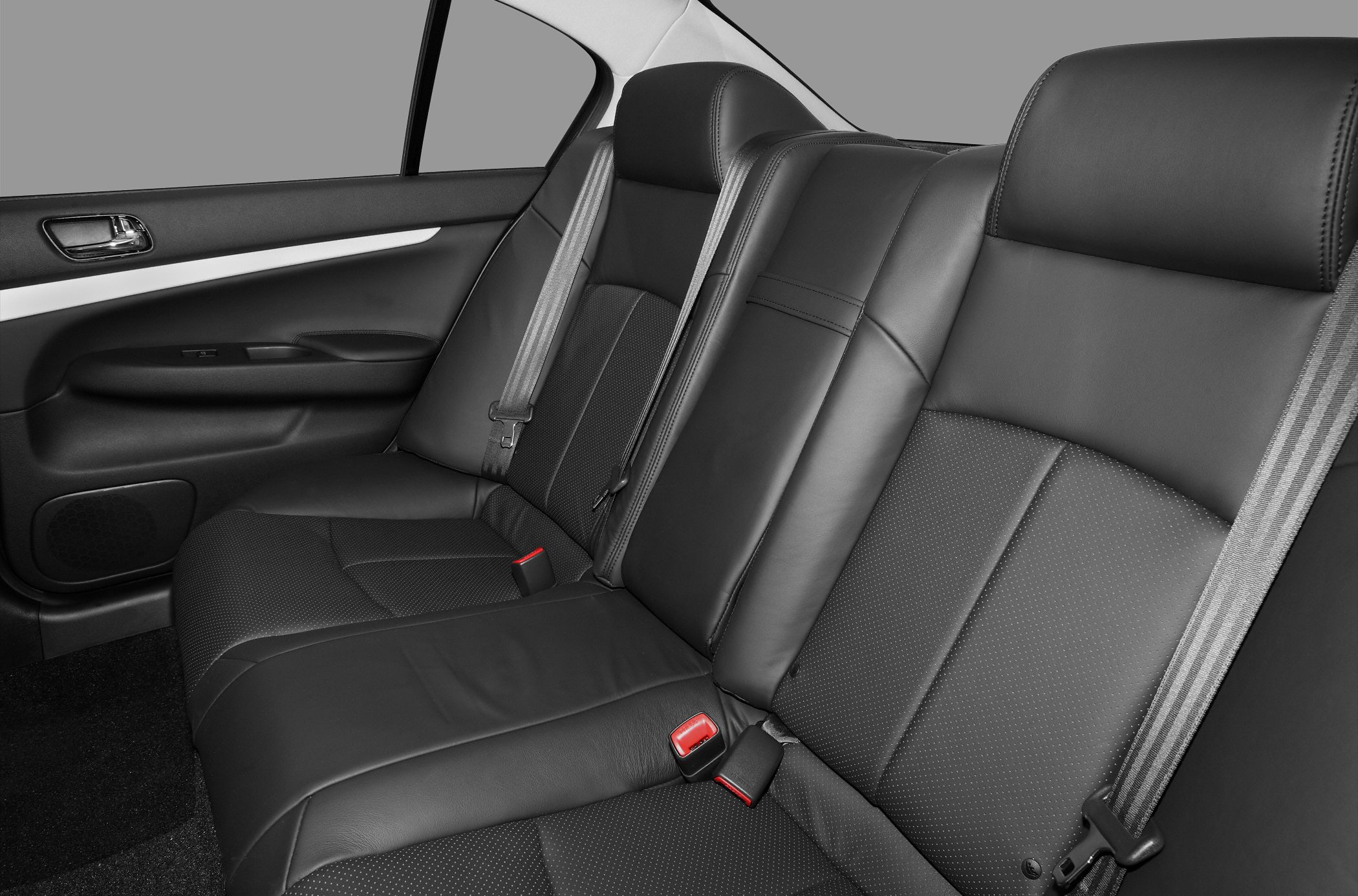 Leather rear seating with seat belts in a sedan interior