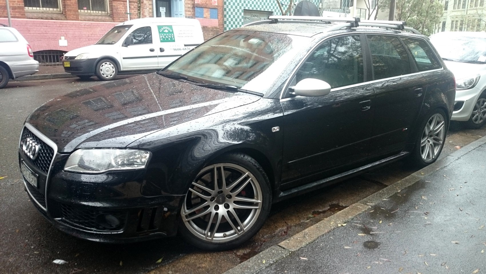 Black station wagon with alloy wheels and silver mirror caps