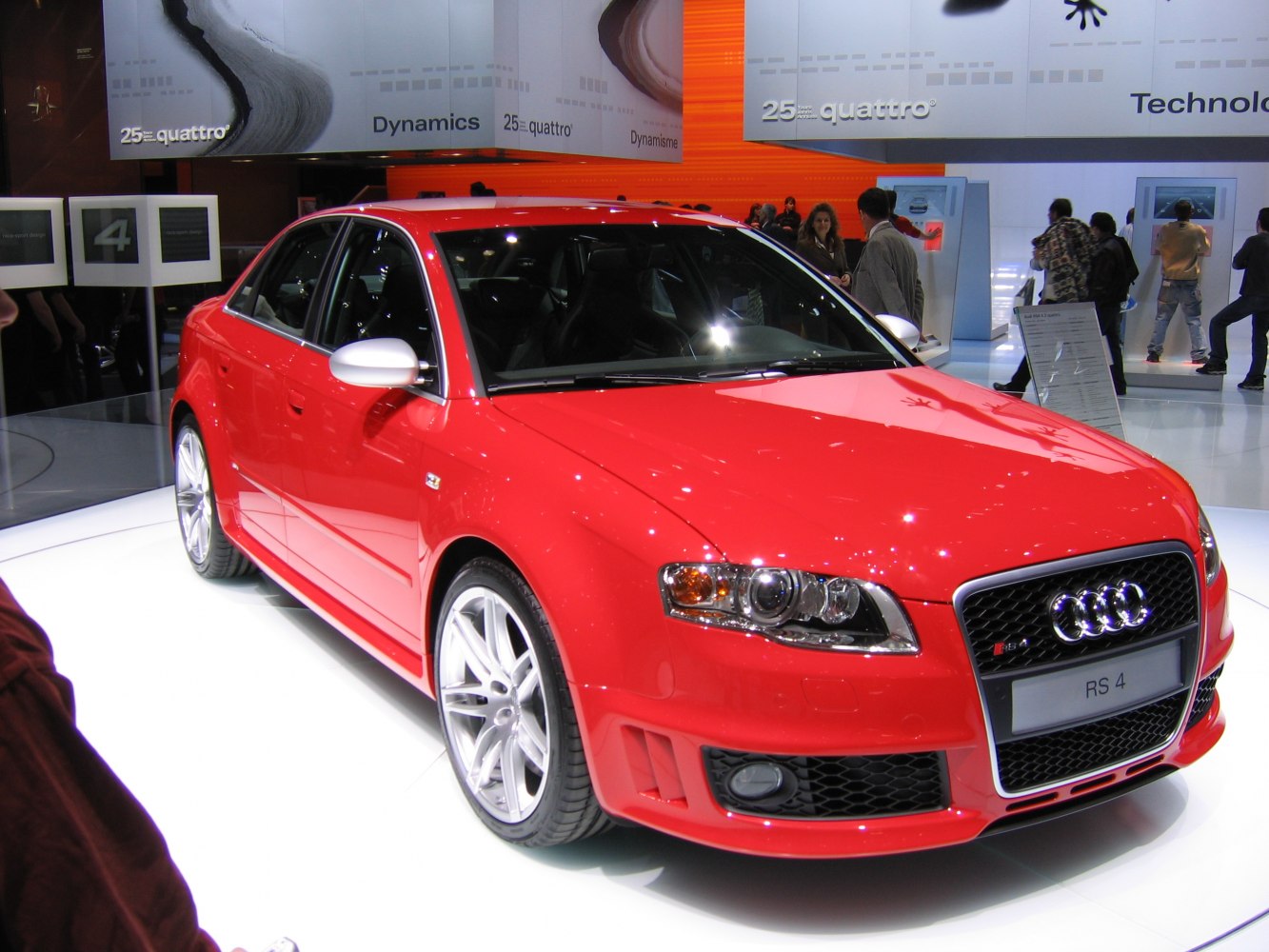 Red sporty sedan with distinctive front and alloy wheels