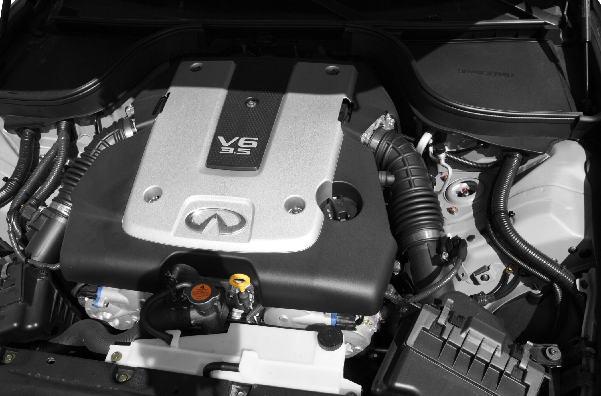 Close-up of V6 3.5L engine bay with engine cover and visible air intake hose
