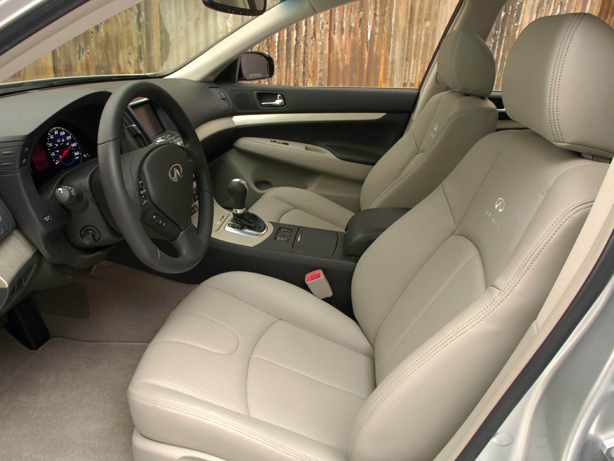 Leather seats, steering wheel, and center console in a sedan interior