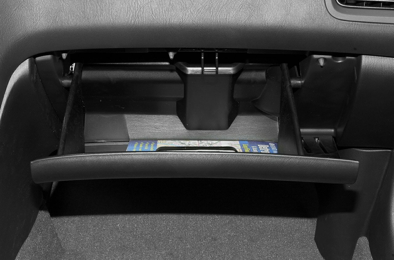 Open glove compartment with visible contents inside.