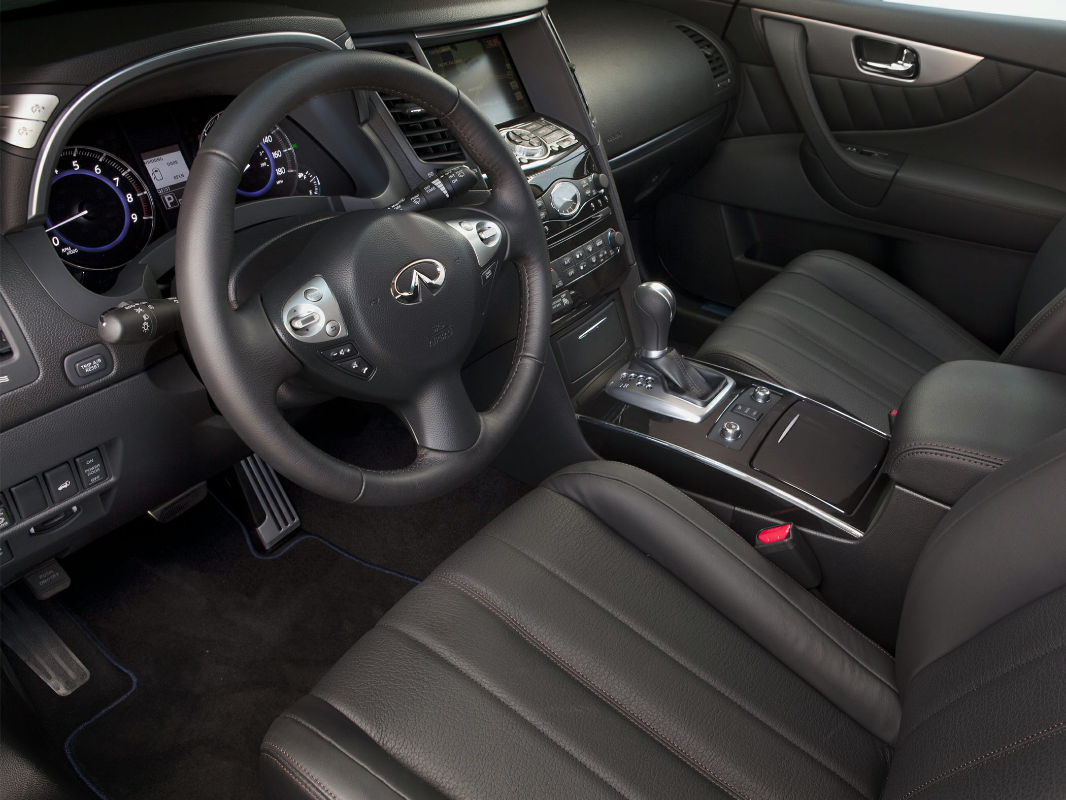 Luxury interior with leather seats, steering wheel, and center console.
