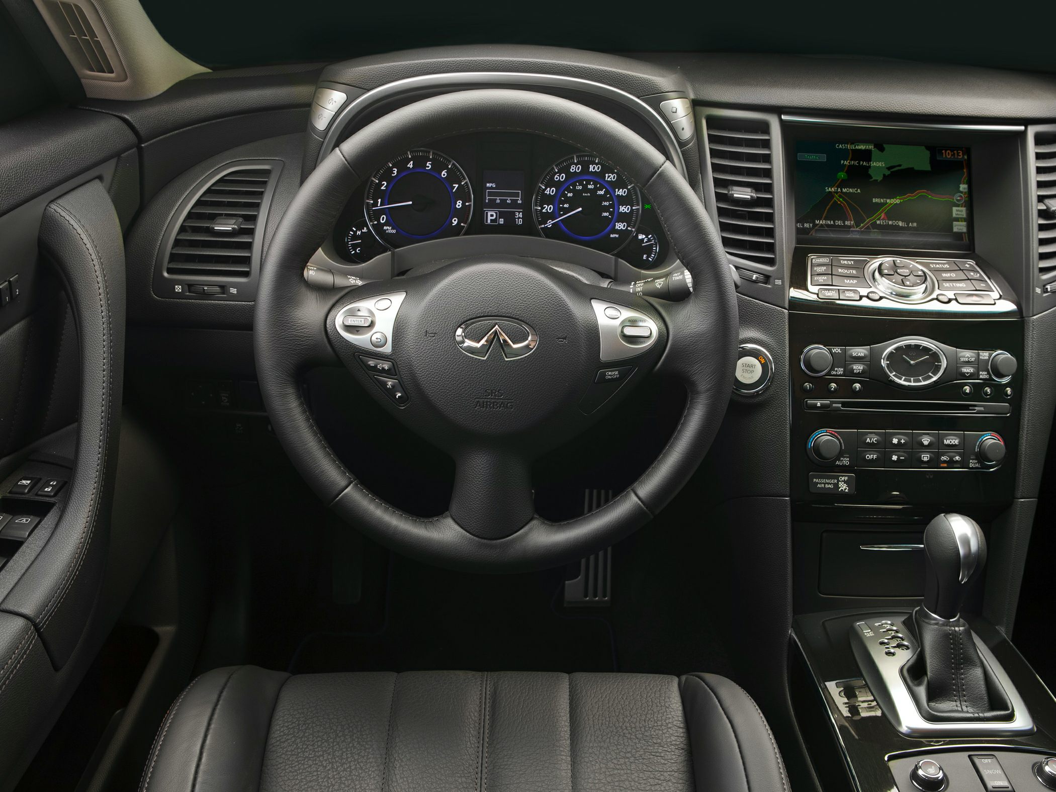 Luxury car interior with steering wheel, dashboard, and navigation display