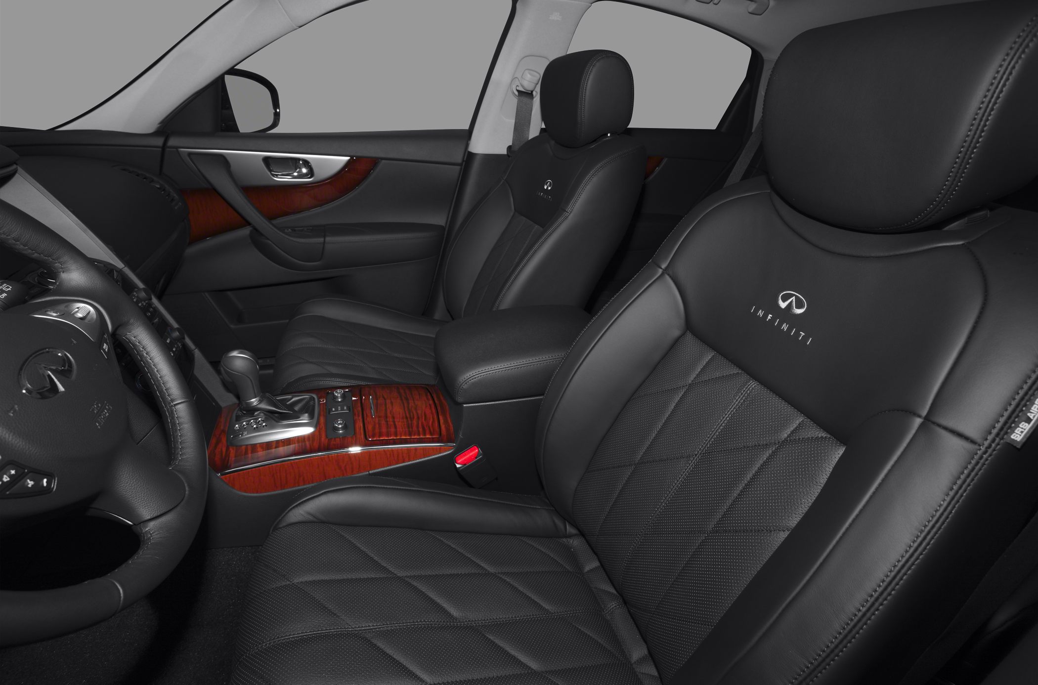 Black leather seats with diamond stitching and wood grain trim on door and console