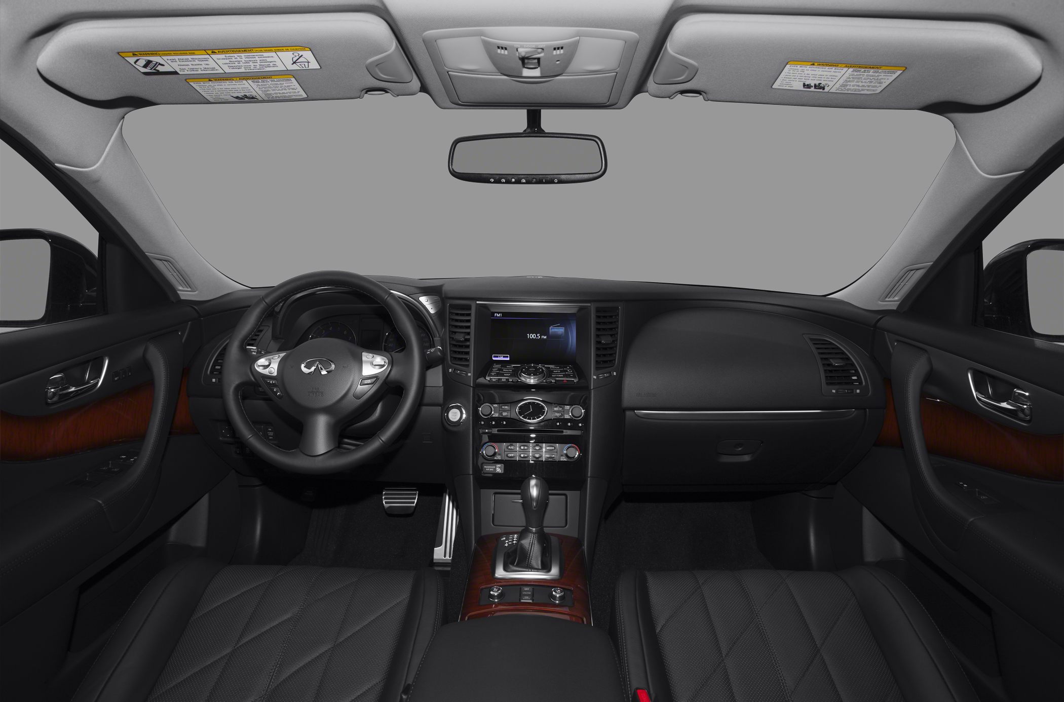 Dashboard and steering wheel with wood trim and infotainment screen