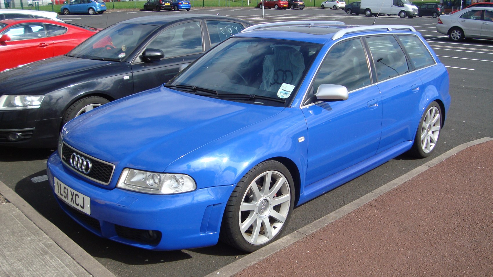 Blue performance wagon with sporty alloy wheels and roof rails