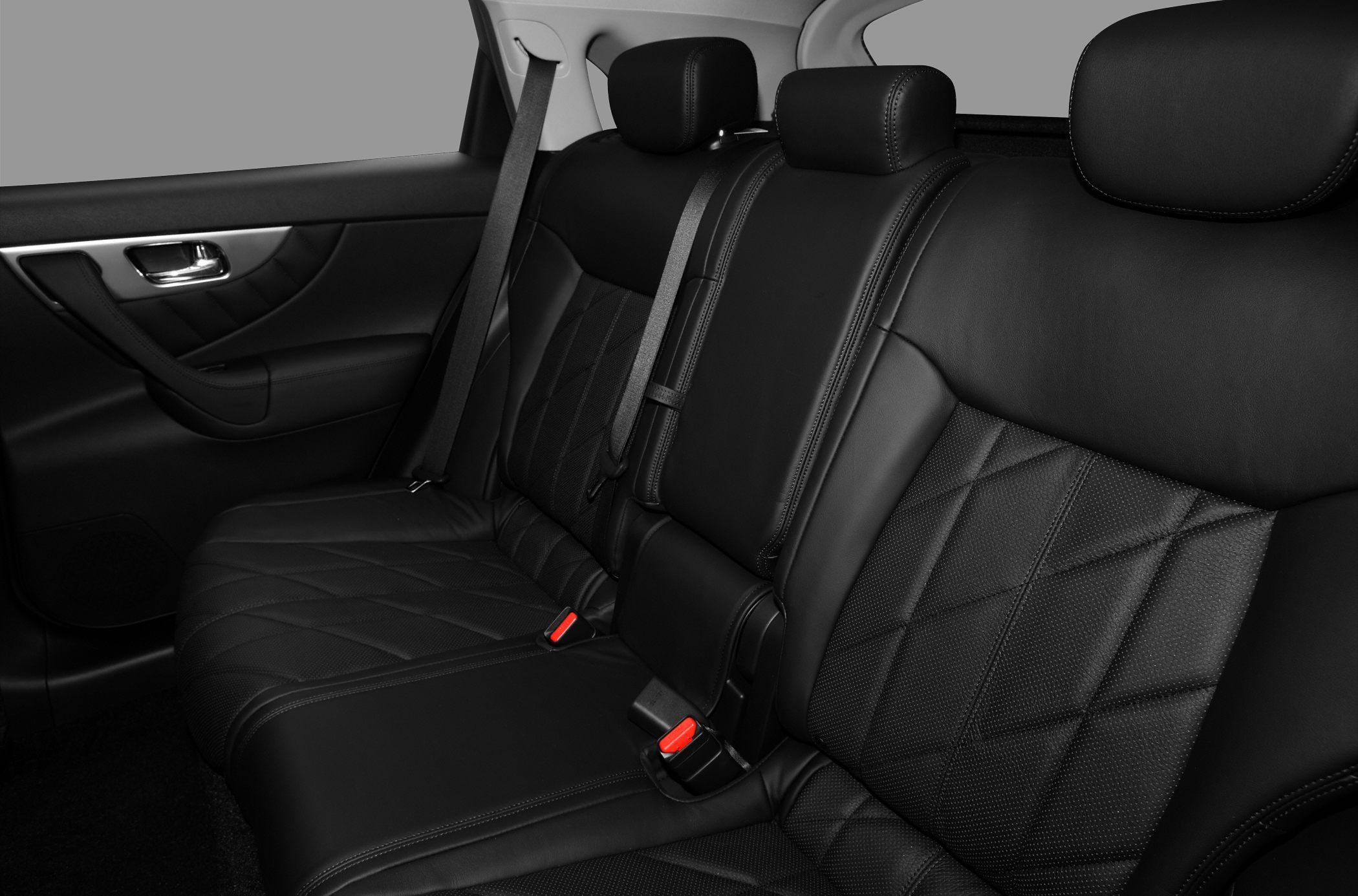 Black quilted leather rear seats with headrests and seat belts.