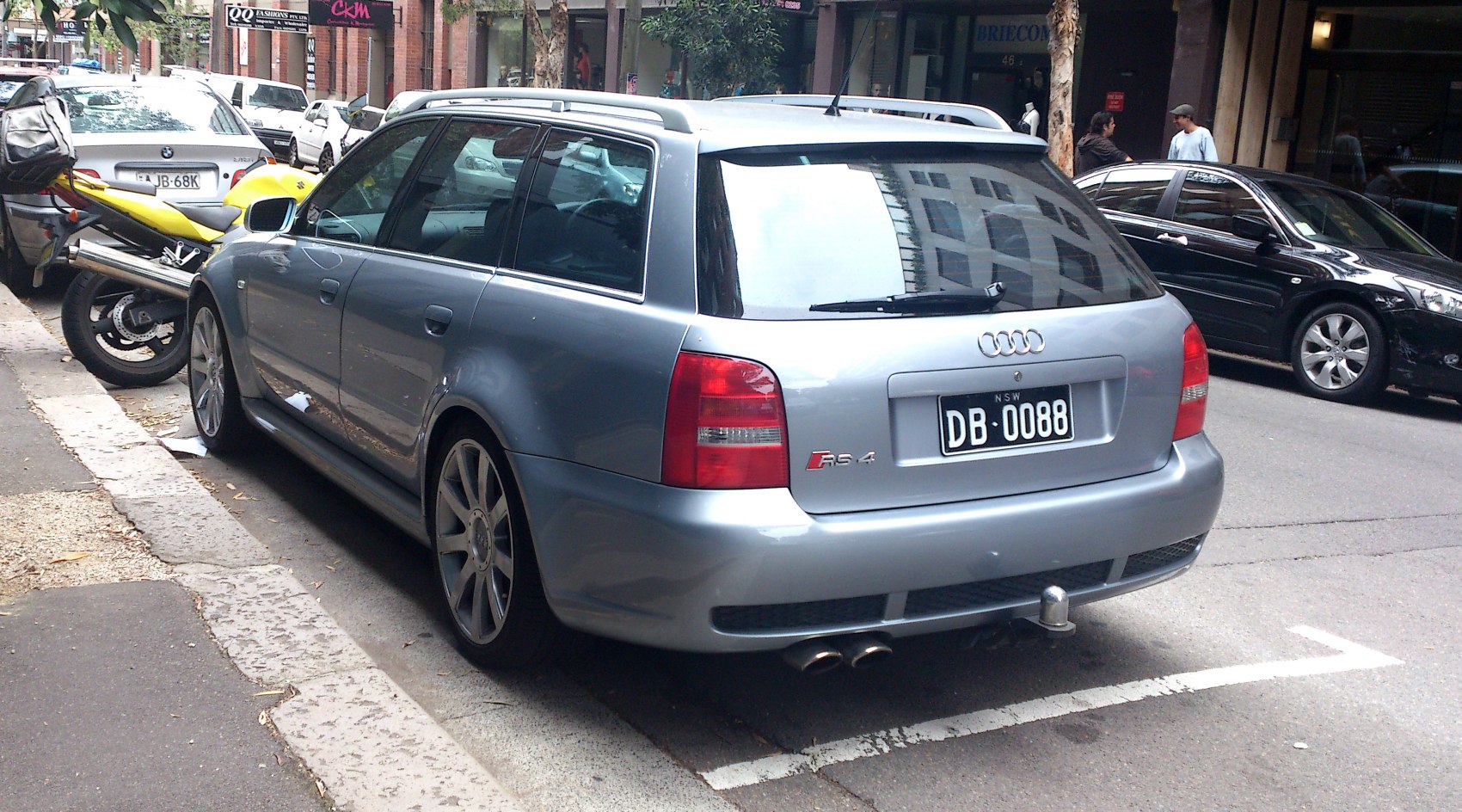 Silver station wagon rear view with dual exhaust and roof rails
