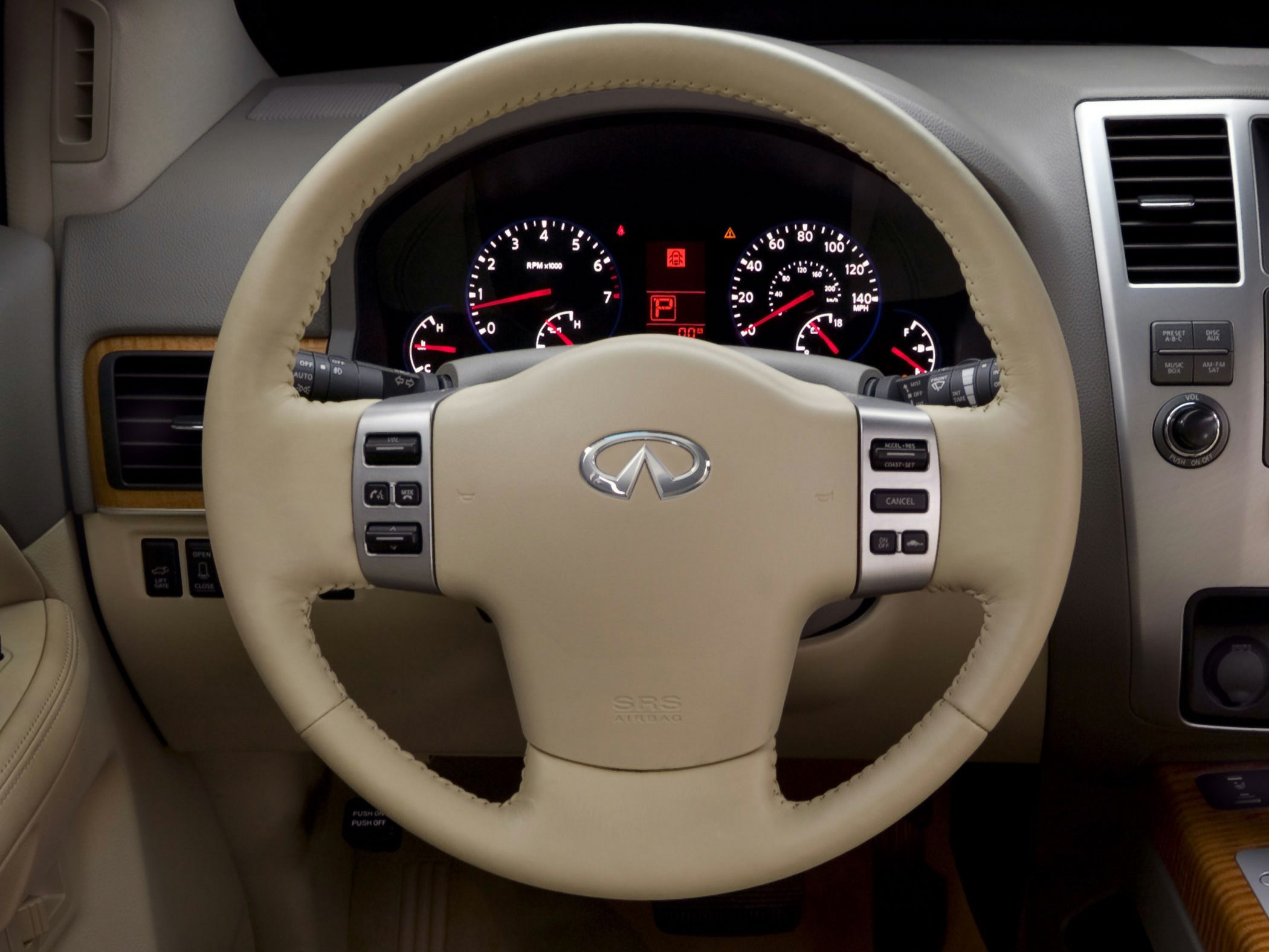 Beige steering wheel with controls and illuminated instrument cluster