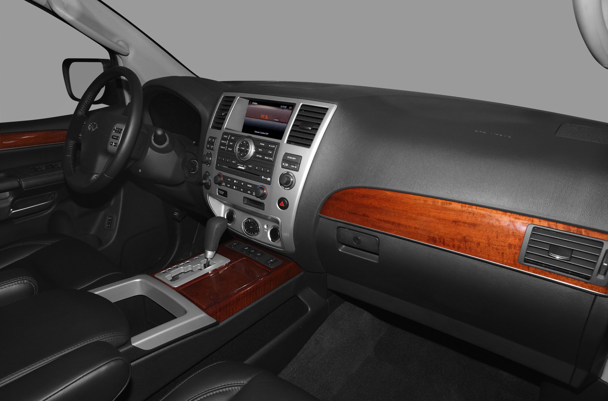 Luxurious dashboard and center console with wood trim and gear shift