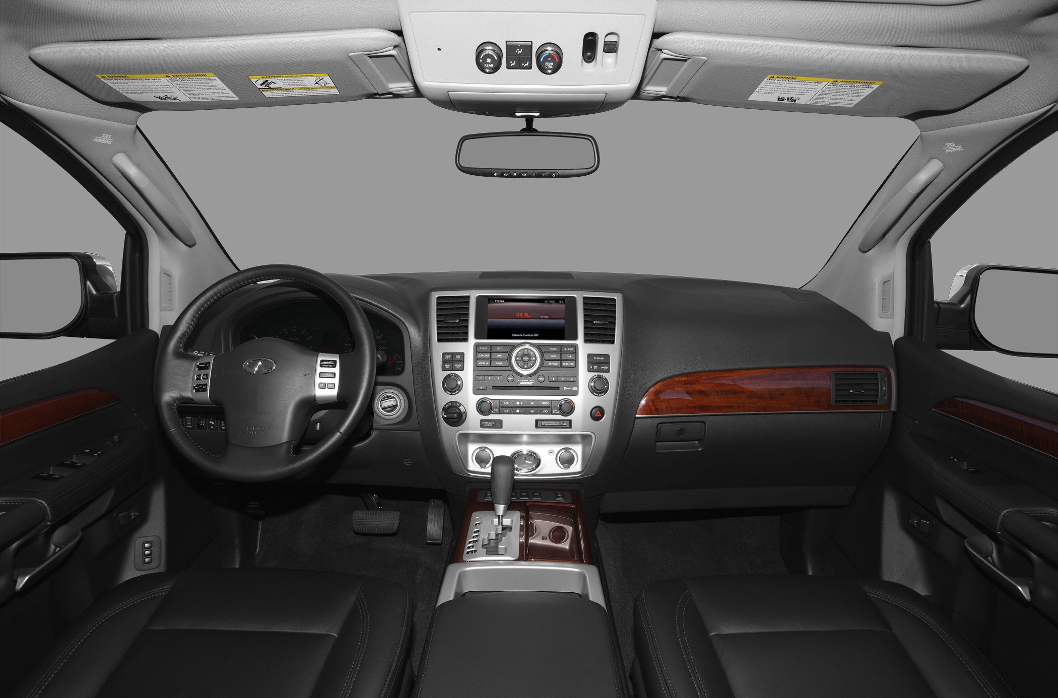 Leather interior with dashboard, wood trim, steering wheel, and gear shift