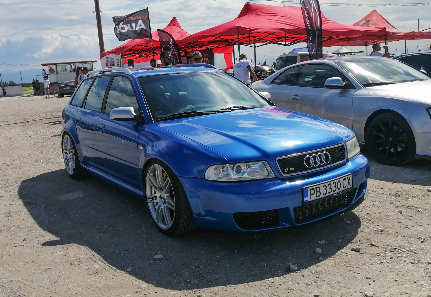 Blue station wagon with sporty wheels and aerodynamic enhancements