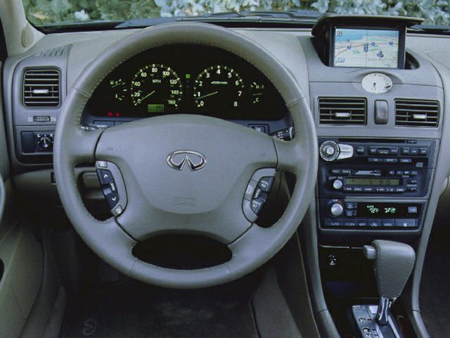 Dashboard with steering wheel, instrument cluster, and pop-up navigation screen