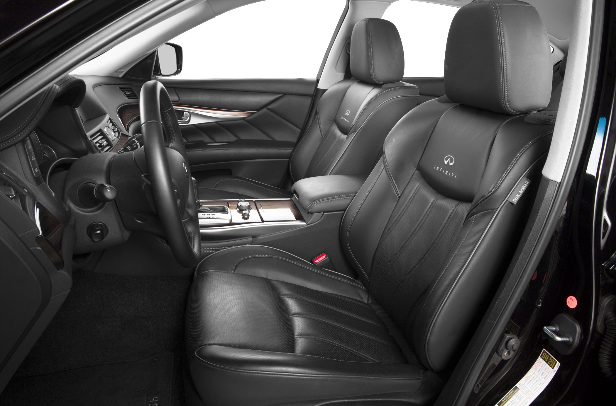 Luxury black leather front seats with detailed stitching and modern dashboard design.