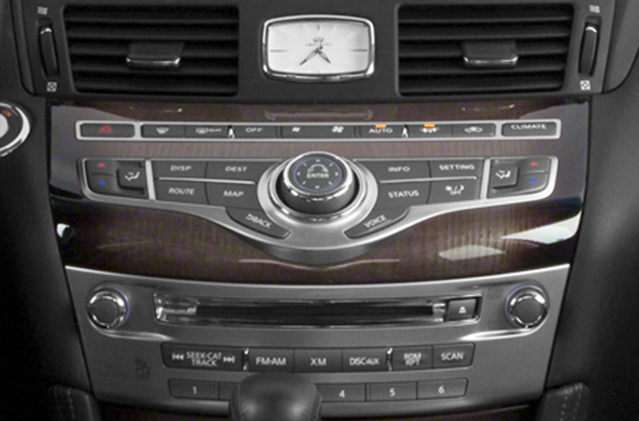 Center console with climate controls, navigation buttons, and analog clock