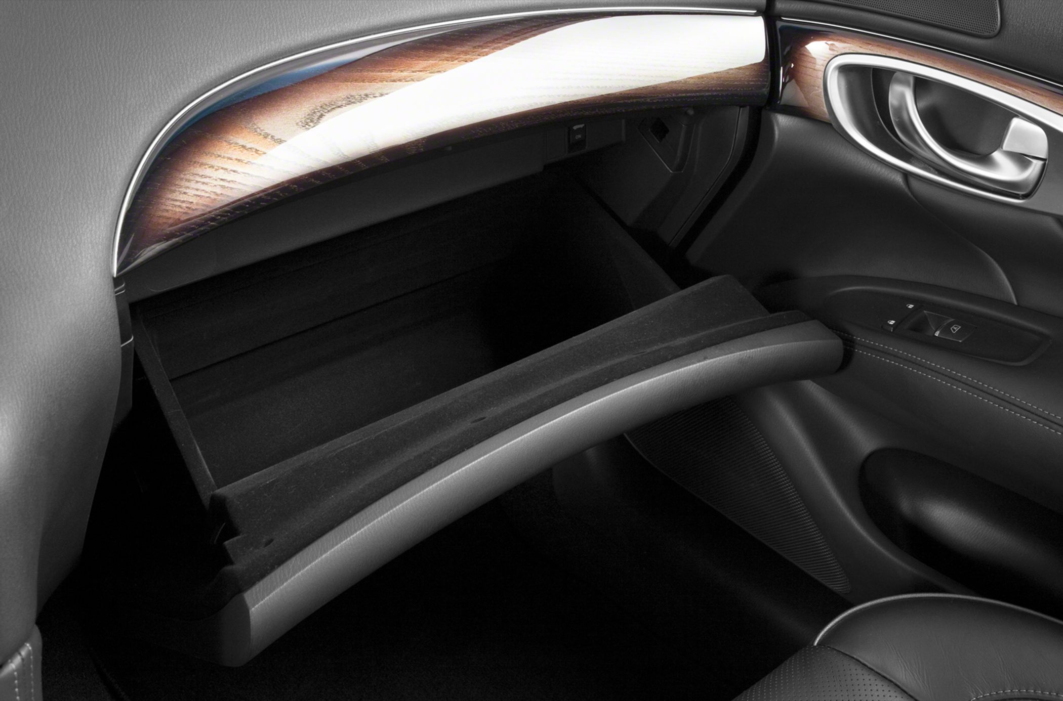 Open glove compartment with wood trim and leather interior details