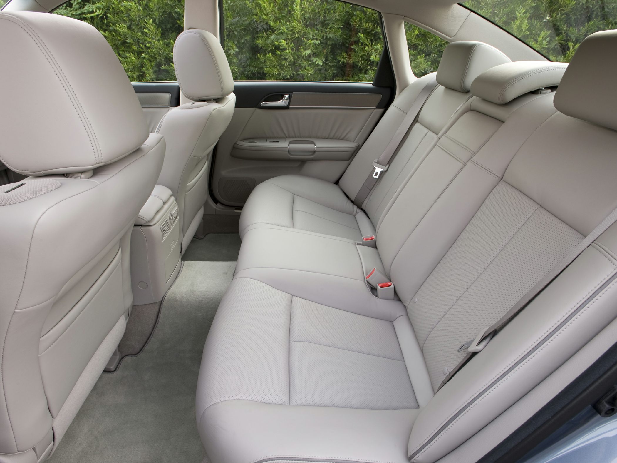Spacious rear seating with light leather upholstery and headrests