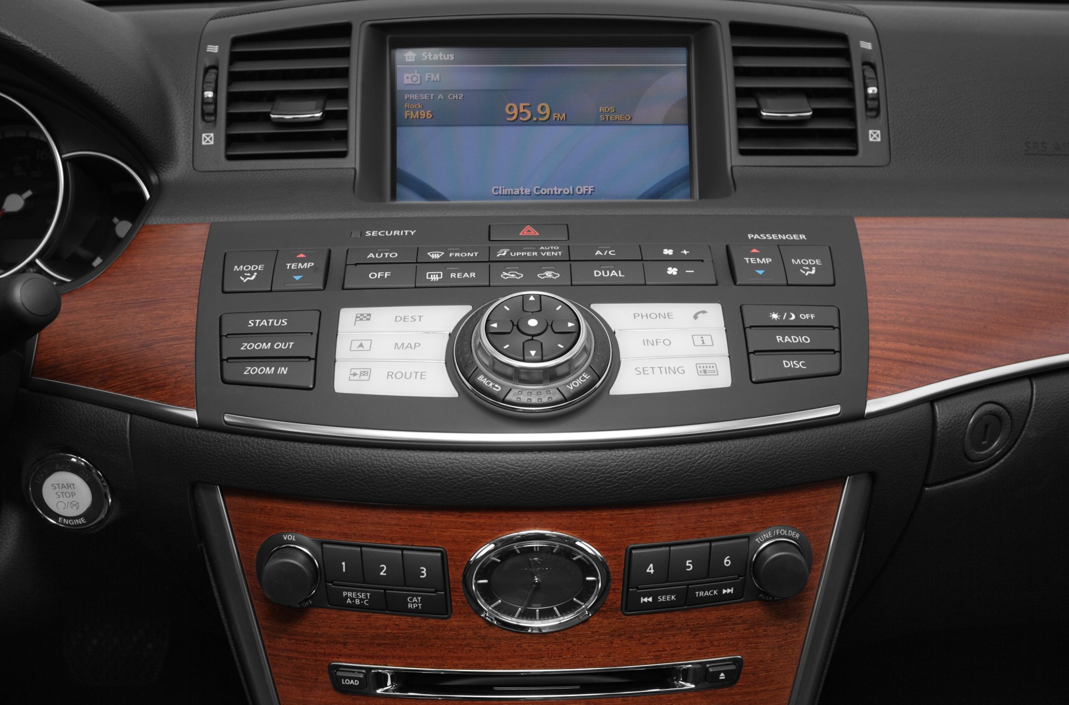 Car dashboard center console with navigation controls and analog clock