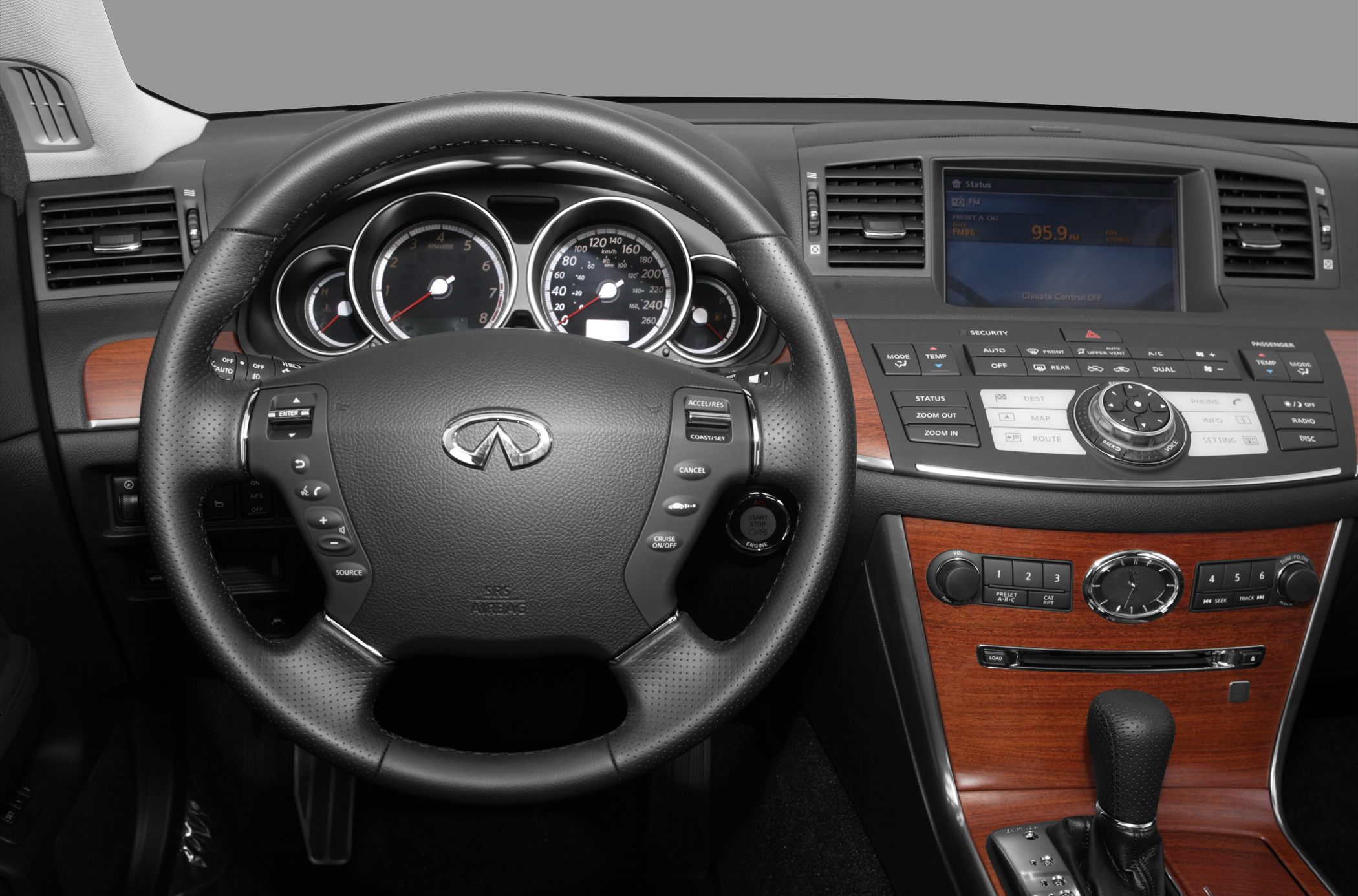 Multifunction steering wheel and wood trim dashboard with analog gauges