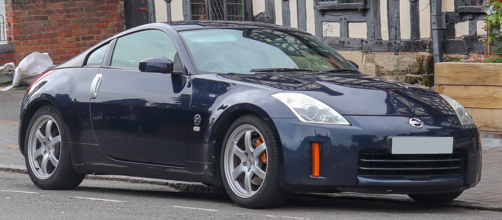 Front side view of a sports coupe showing sleek headlights and aerodynamic body