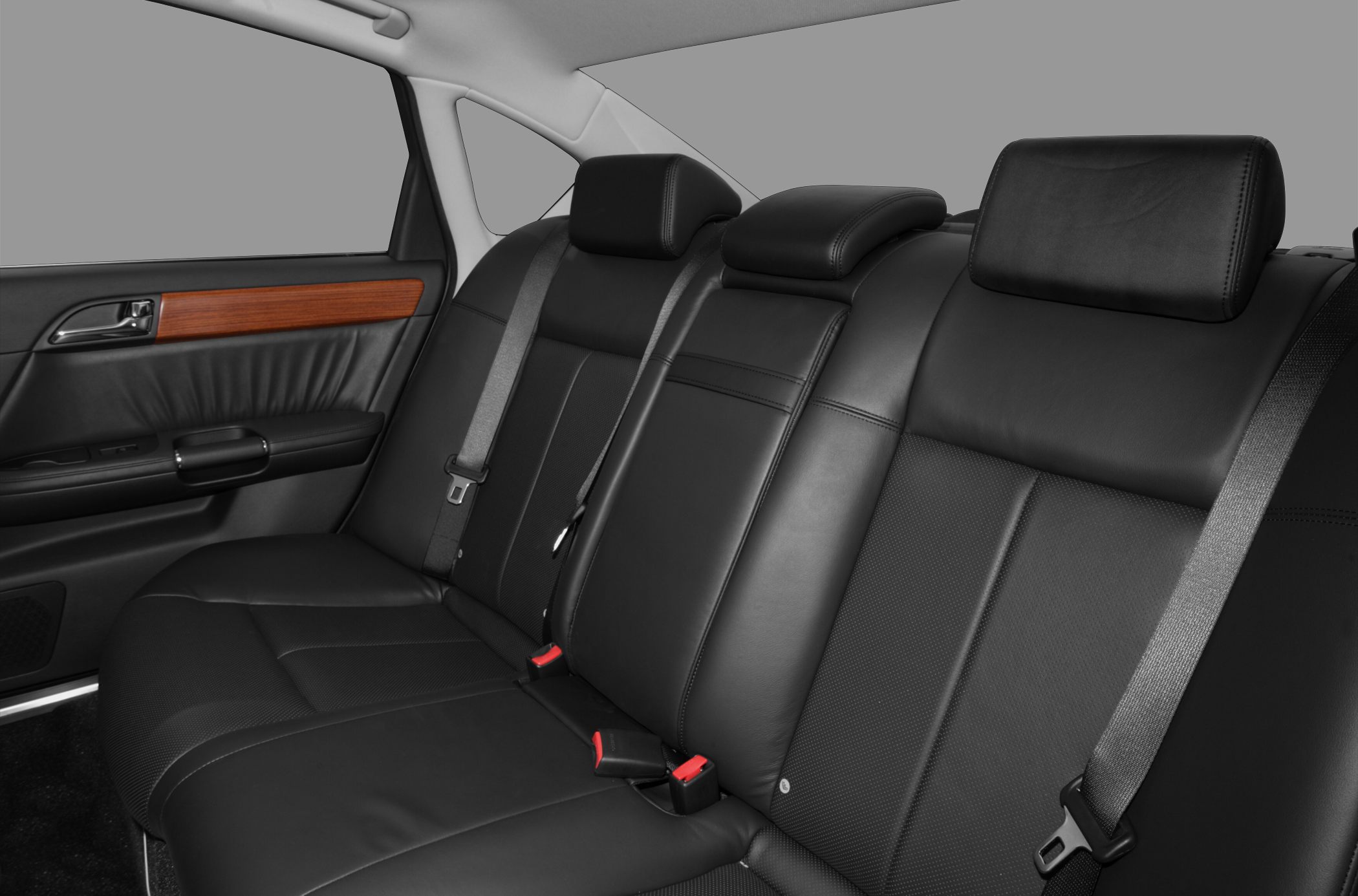 Black leather rear seat with wood trim and three headrests
