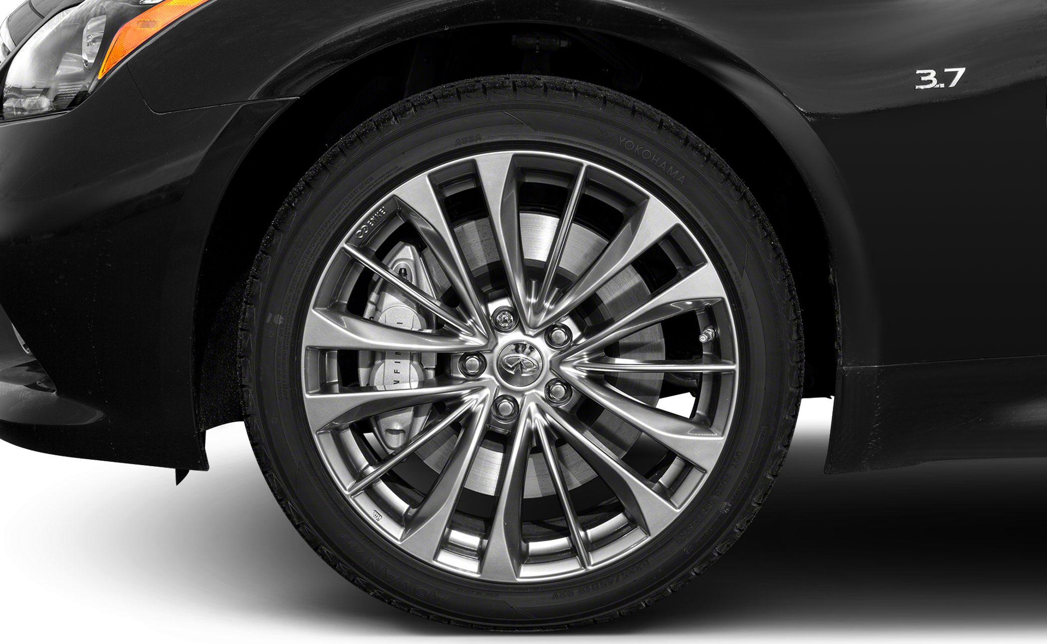 Intricate alloy wheel with visible brake caliper and disc.