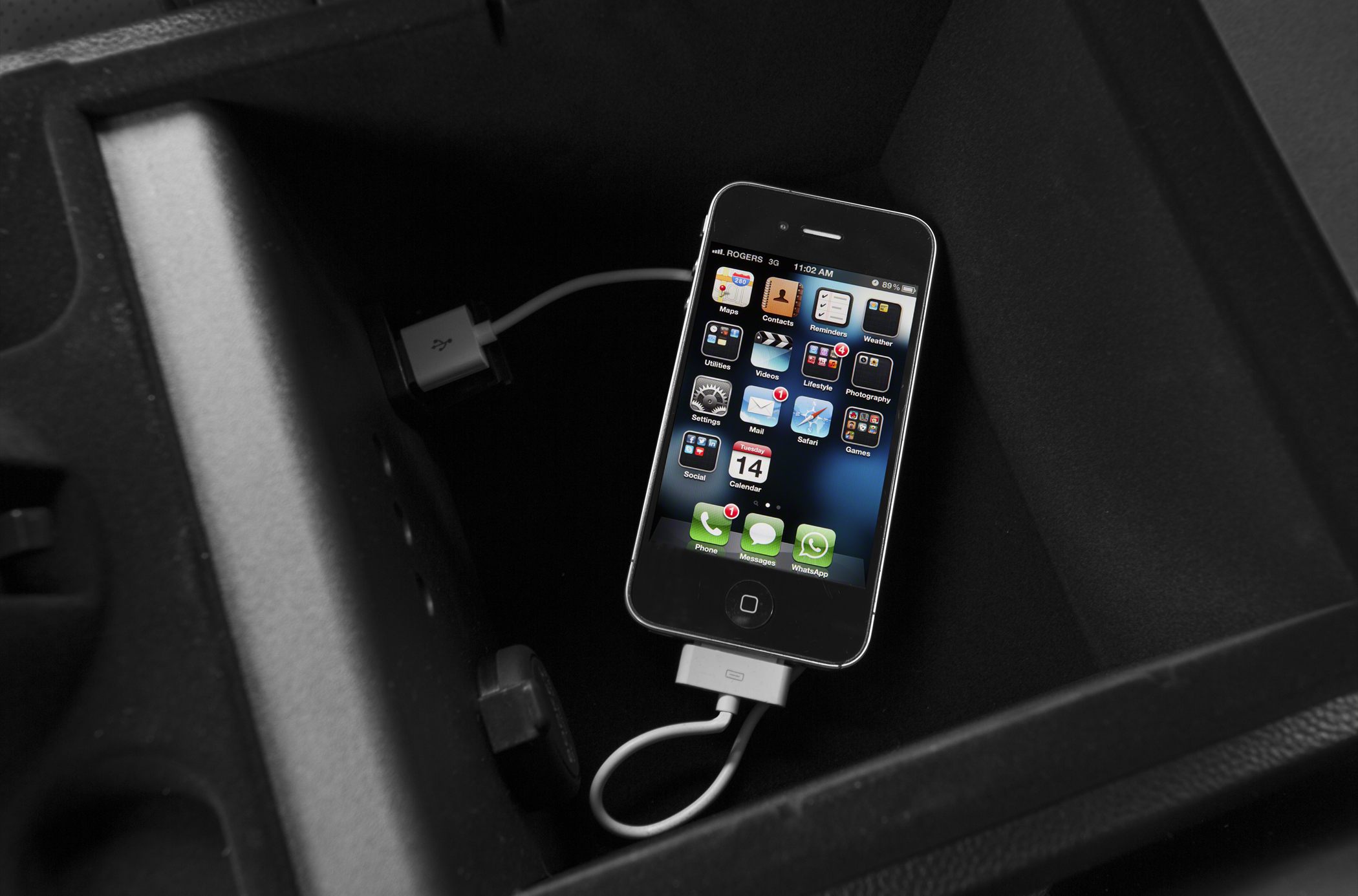 Phone charging and USB connectivity in car storage compartment