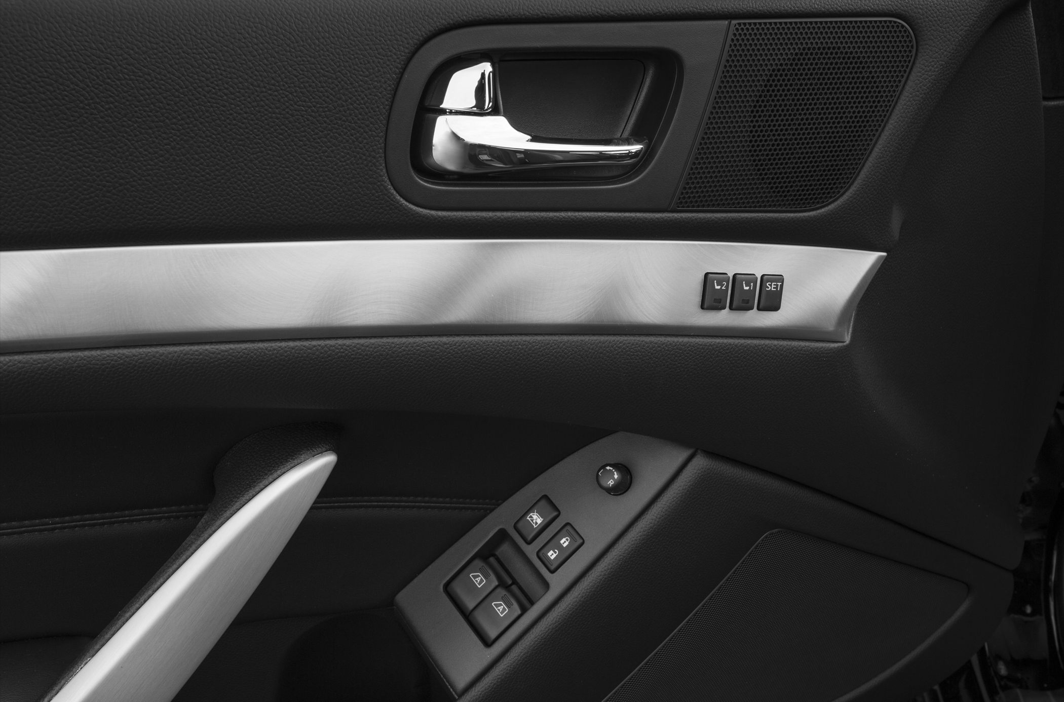 Car door panel with memory seat buttons and window controls