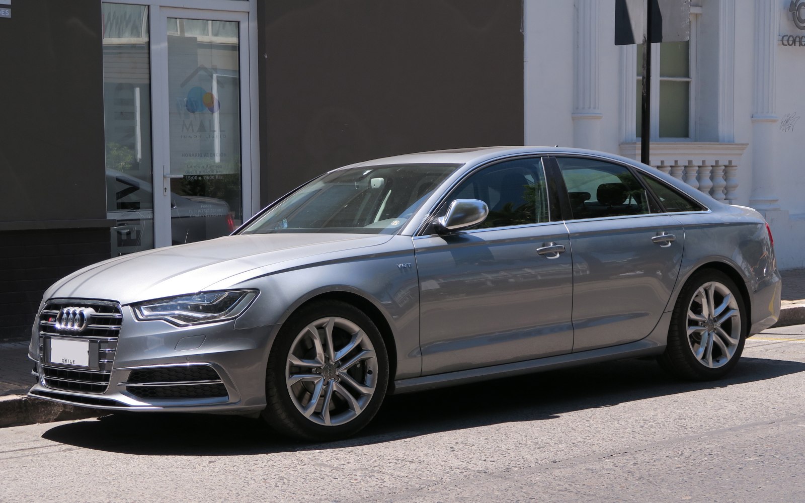 Silver four-door sedan with alloy wheels and V8T badge