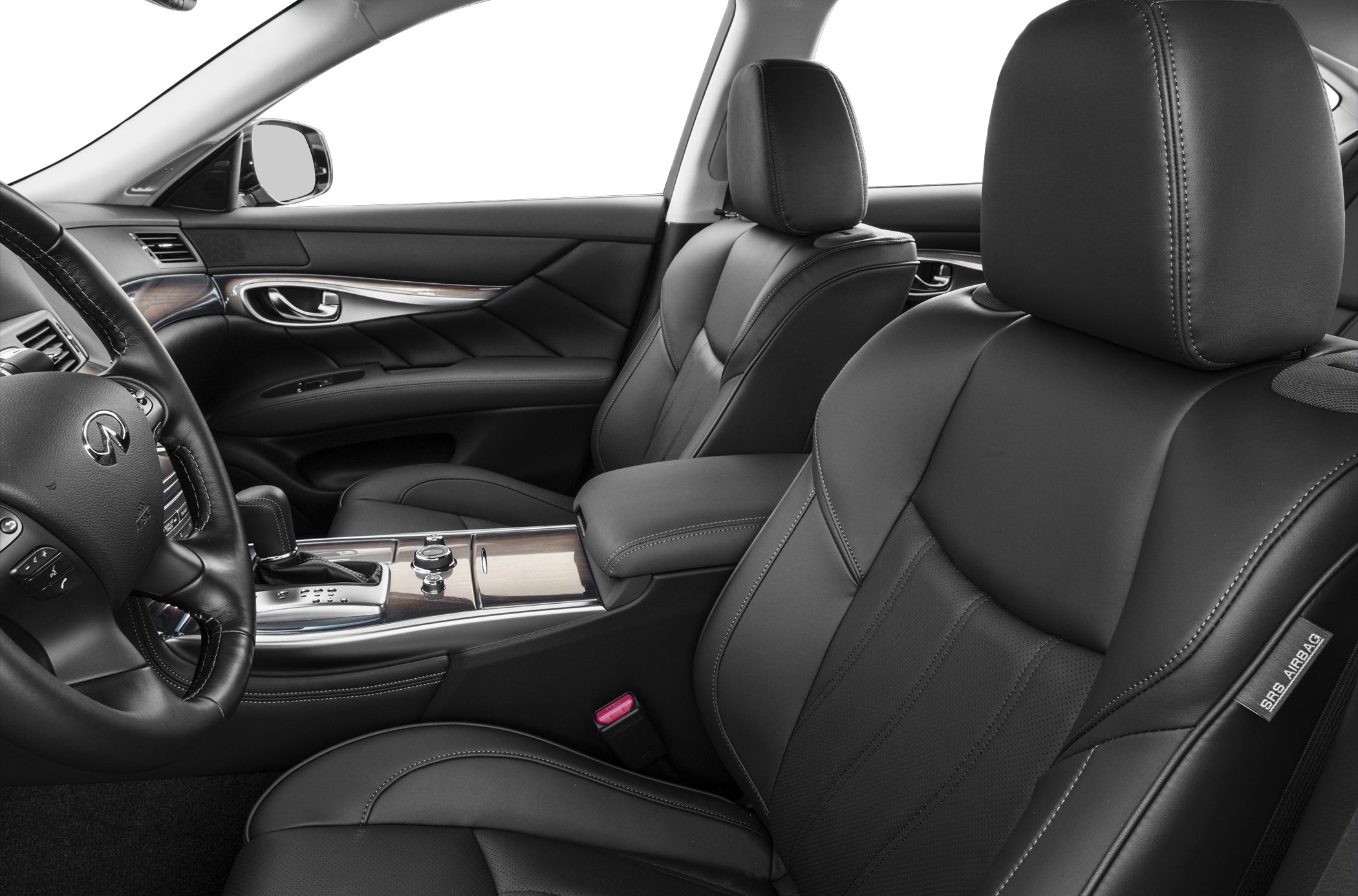 Leather seats and wood-trimmed center console in luxury car interior