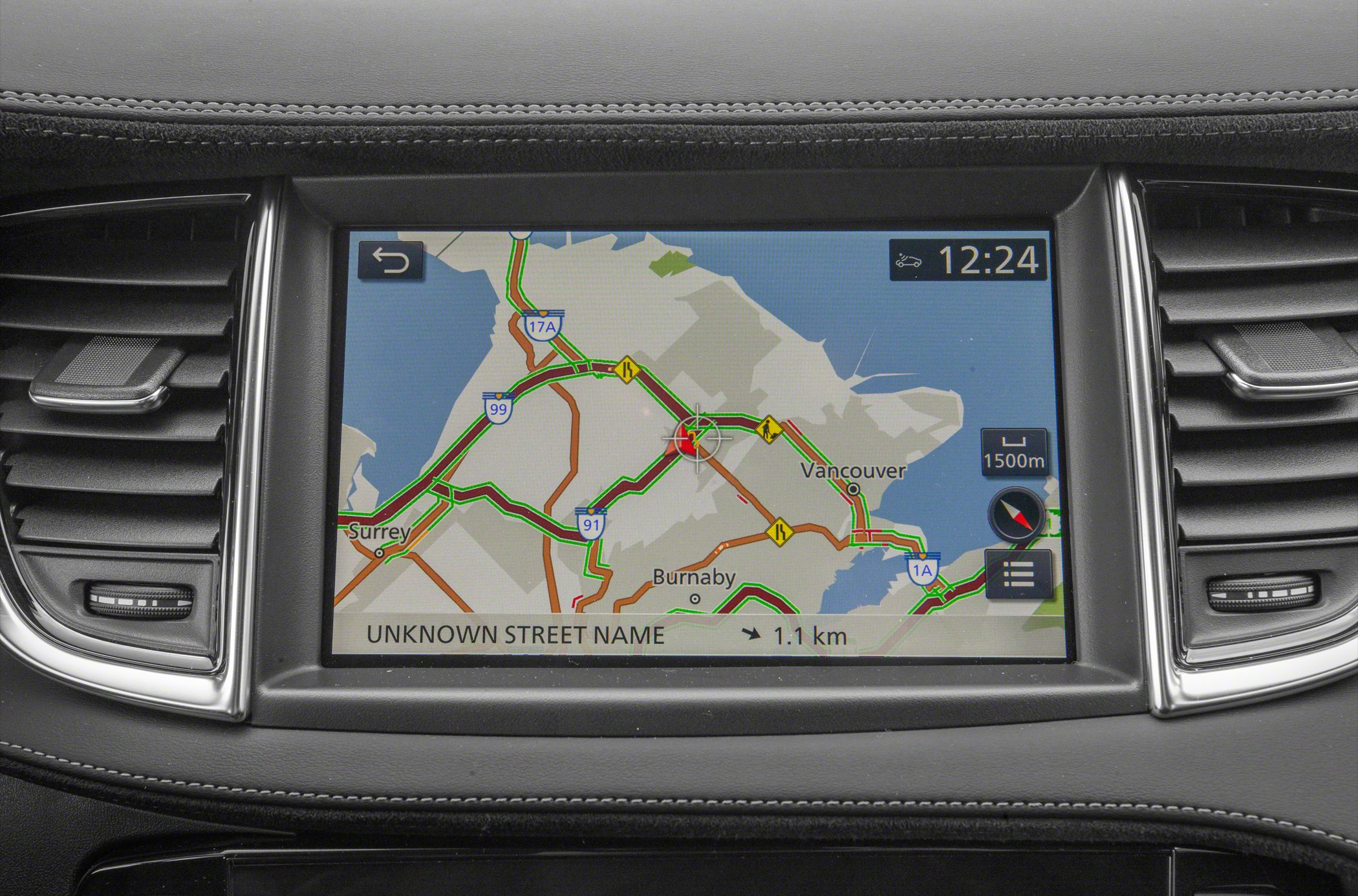 Vehicle infotainment touchscreen showing traffic map and route navigation.