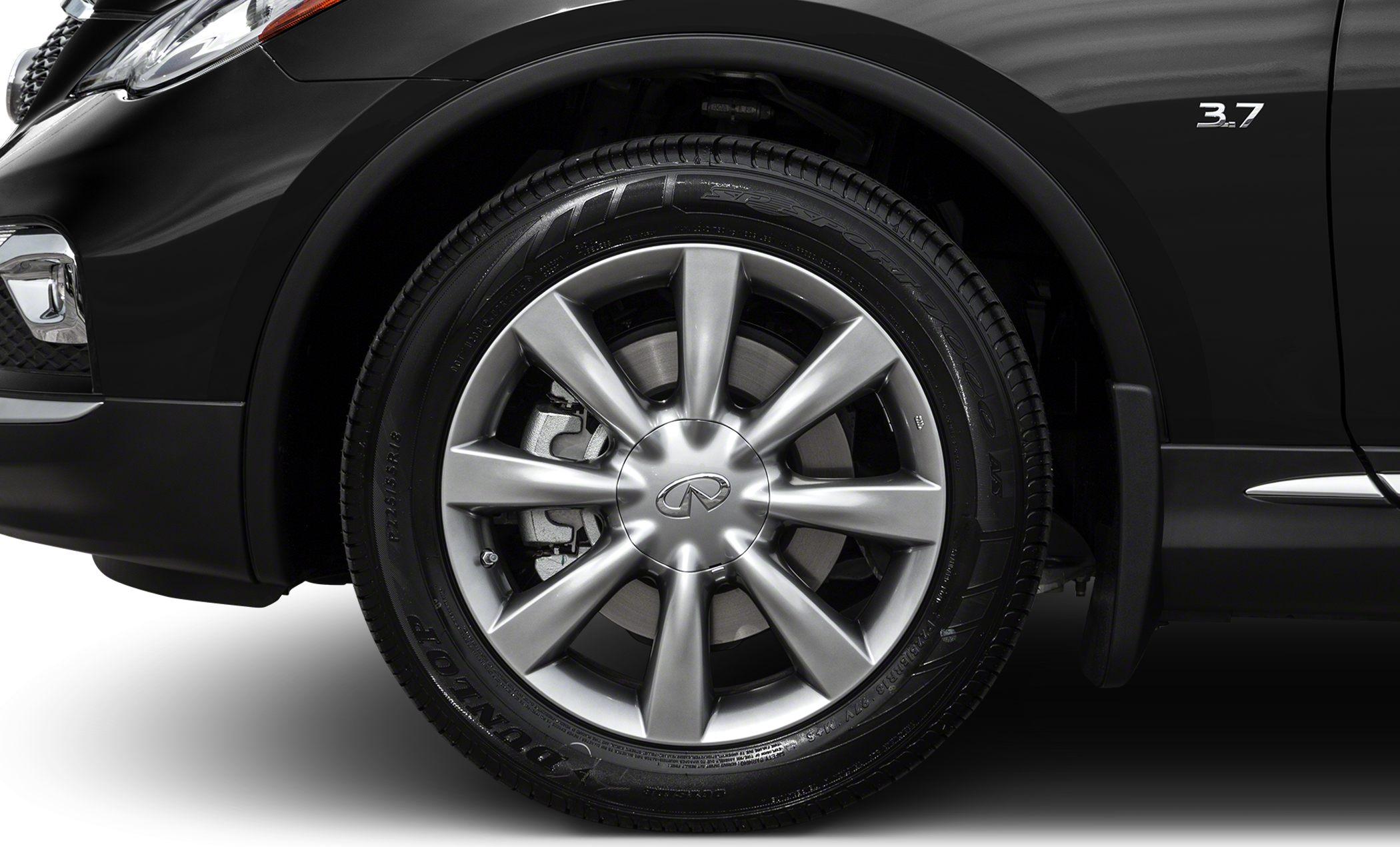 Close-up of alloy wheel and 3.7 engine badge on black vehicle side