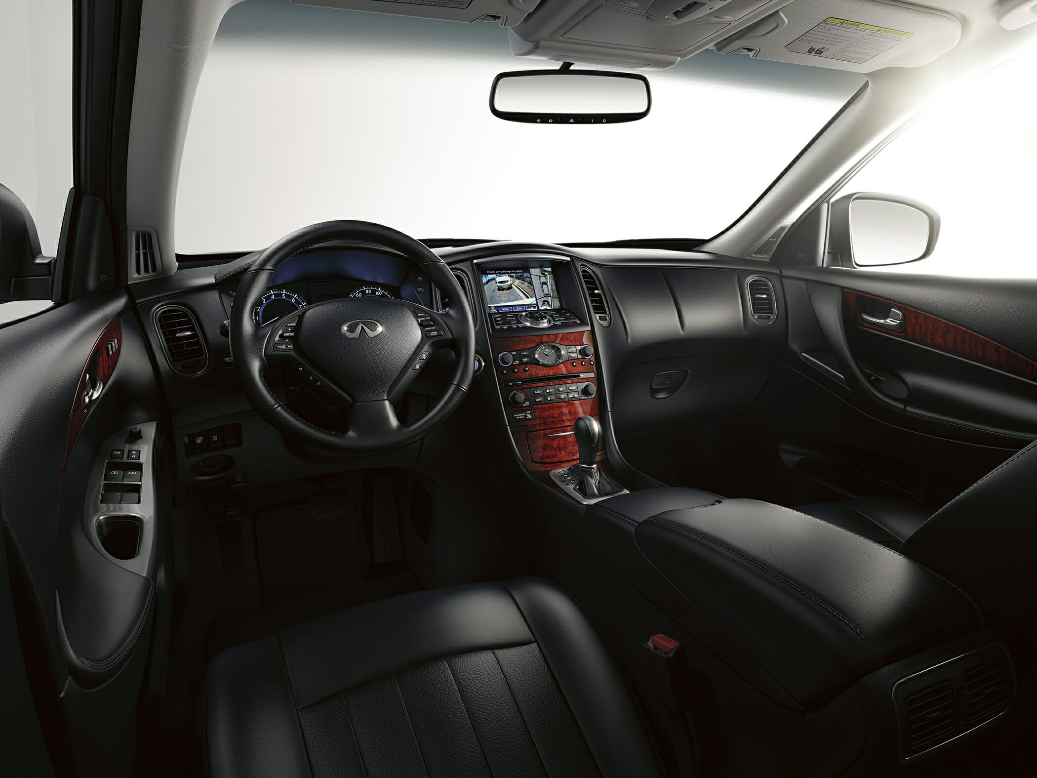 Luxurious car interior with leather steering wheel and wood-trimmed dashboard