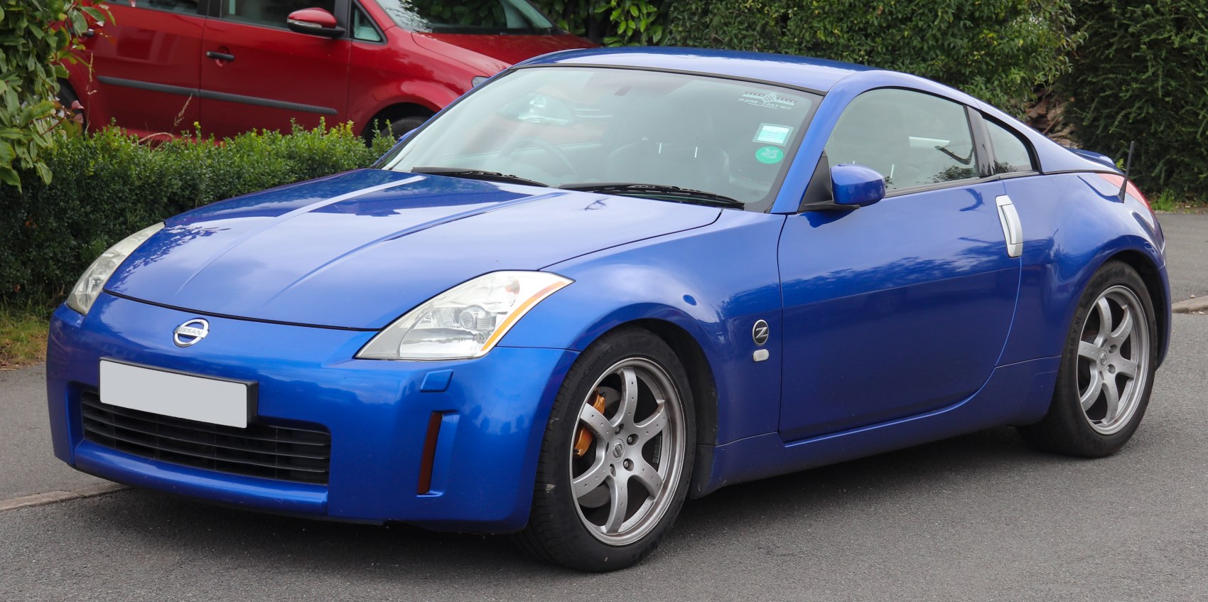 Blue sports coupe with distinctive front headlights and alloy wheels