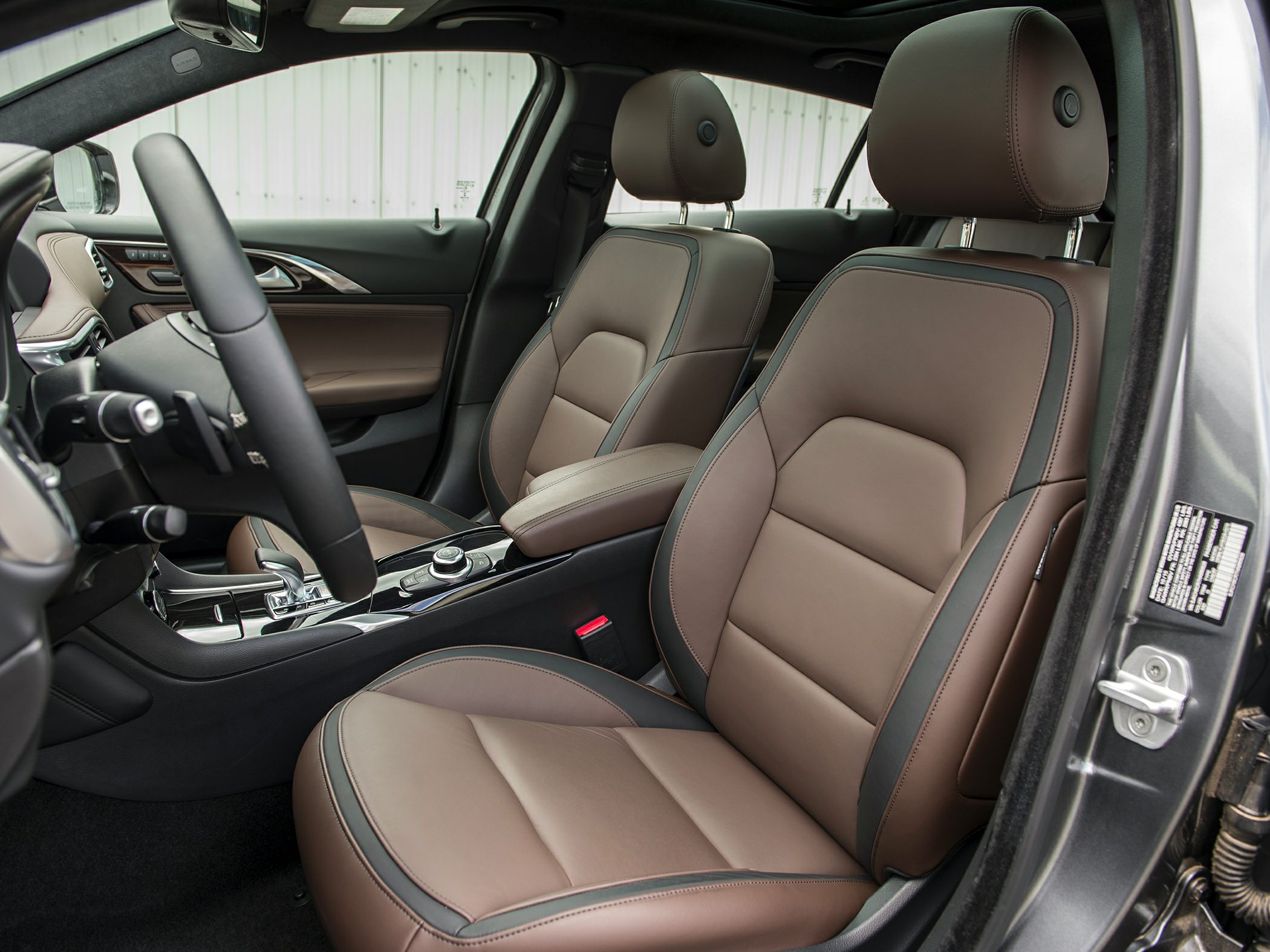 Leather seats and central console with controls inside a car cabin
